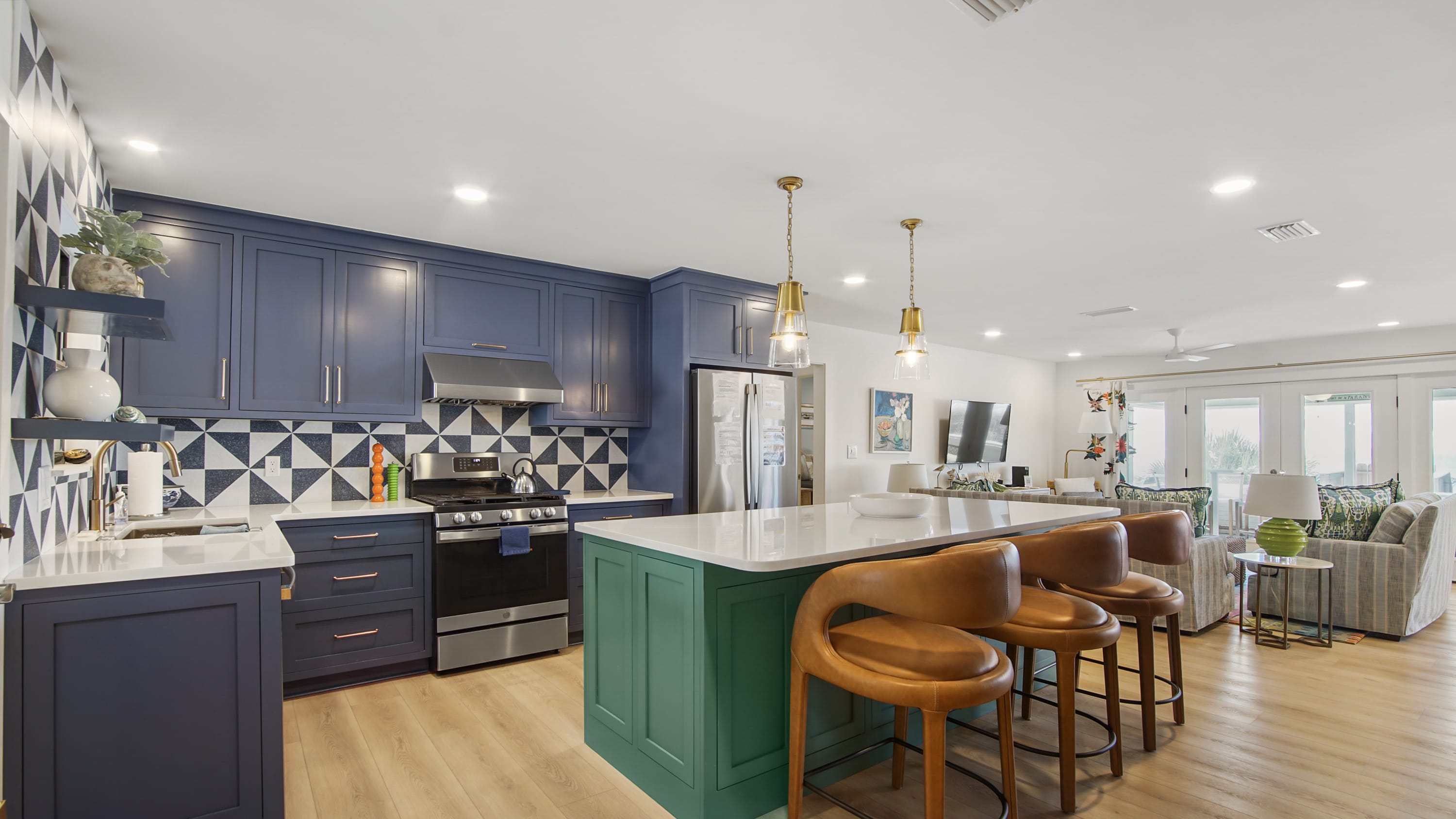 Kitchen with 3 barstools and bar dining area