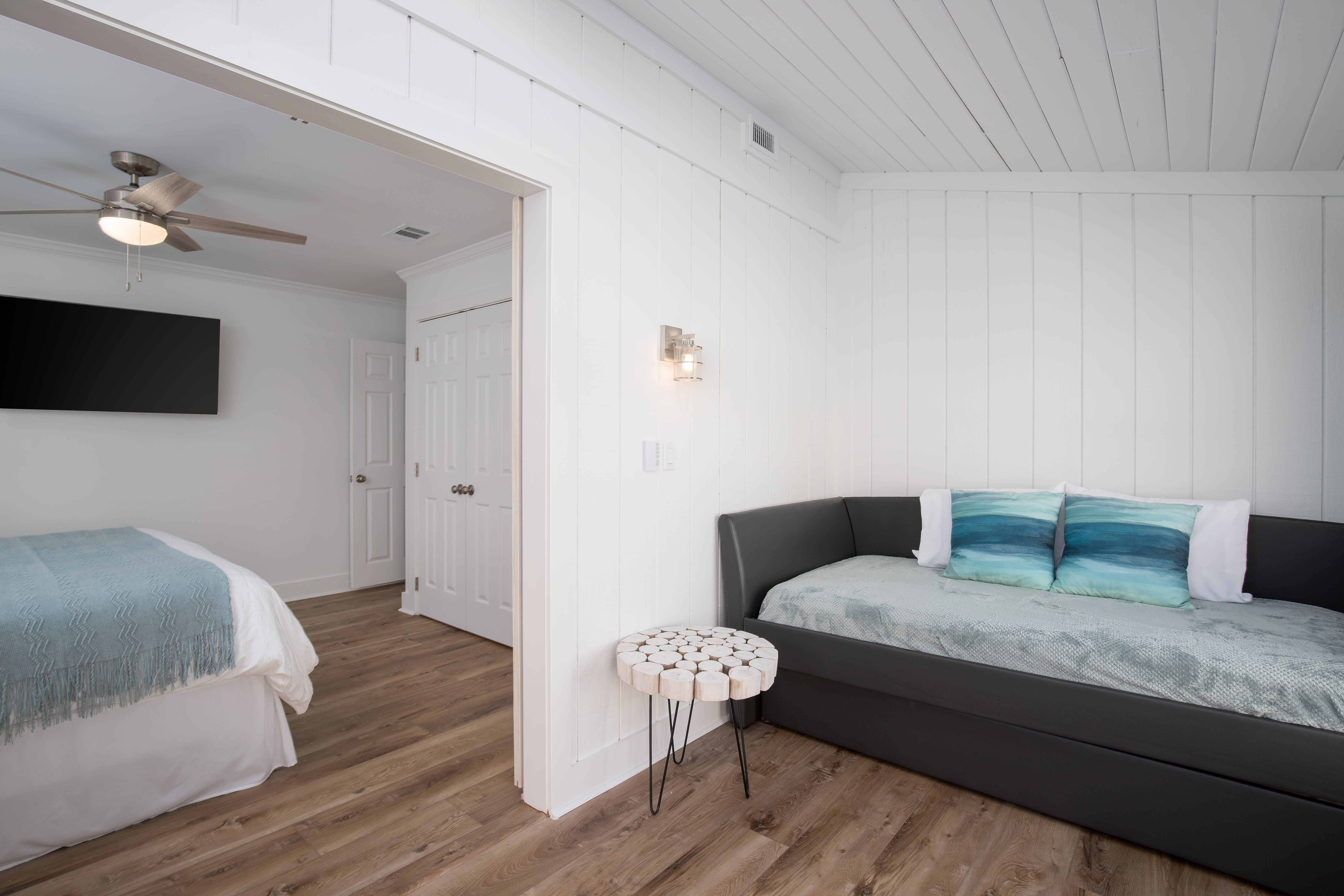 Sunroom offers a chair and daybed with trundle so it could be utilized as extra living space or sleeping area.