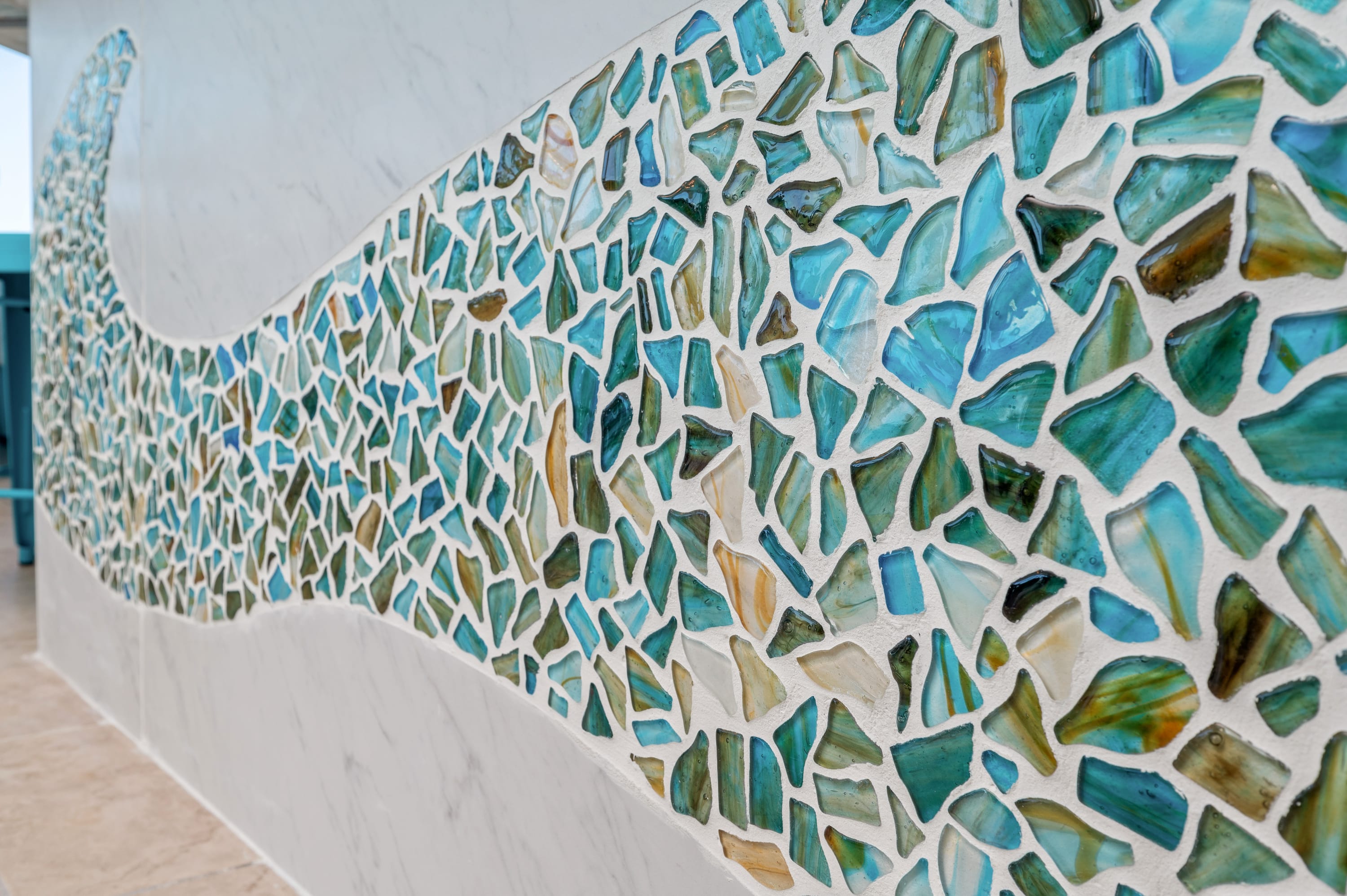 A custom wave mosaic design creates a one of a kind accent in the kitchen