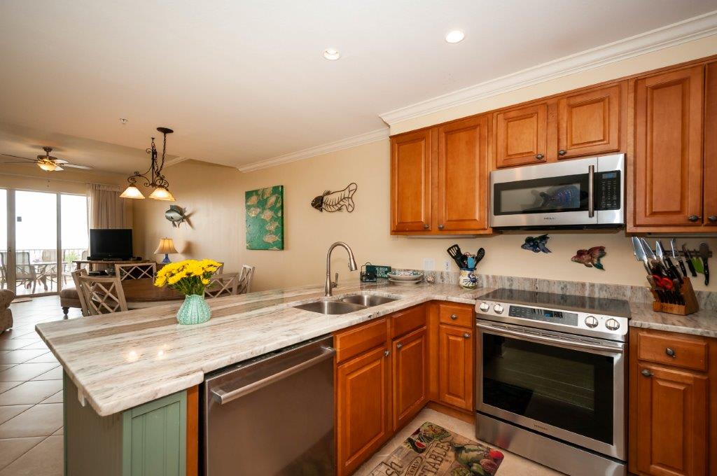 new kitchen with granite counters and stainless appliances