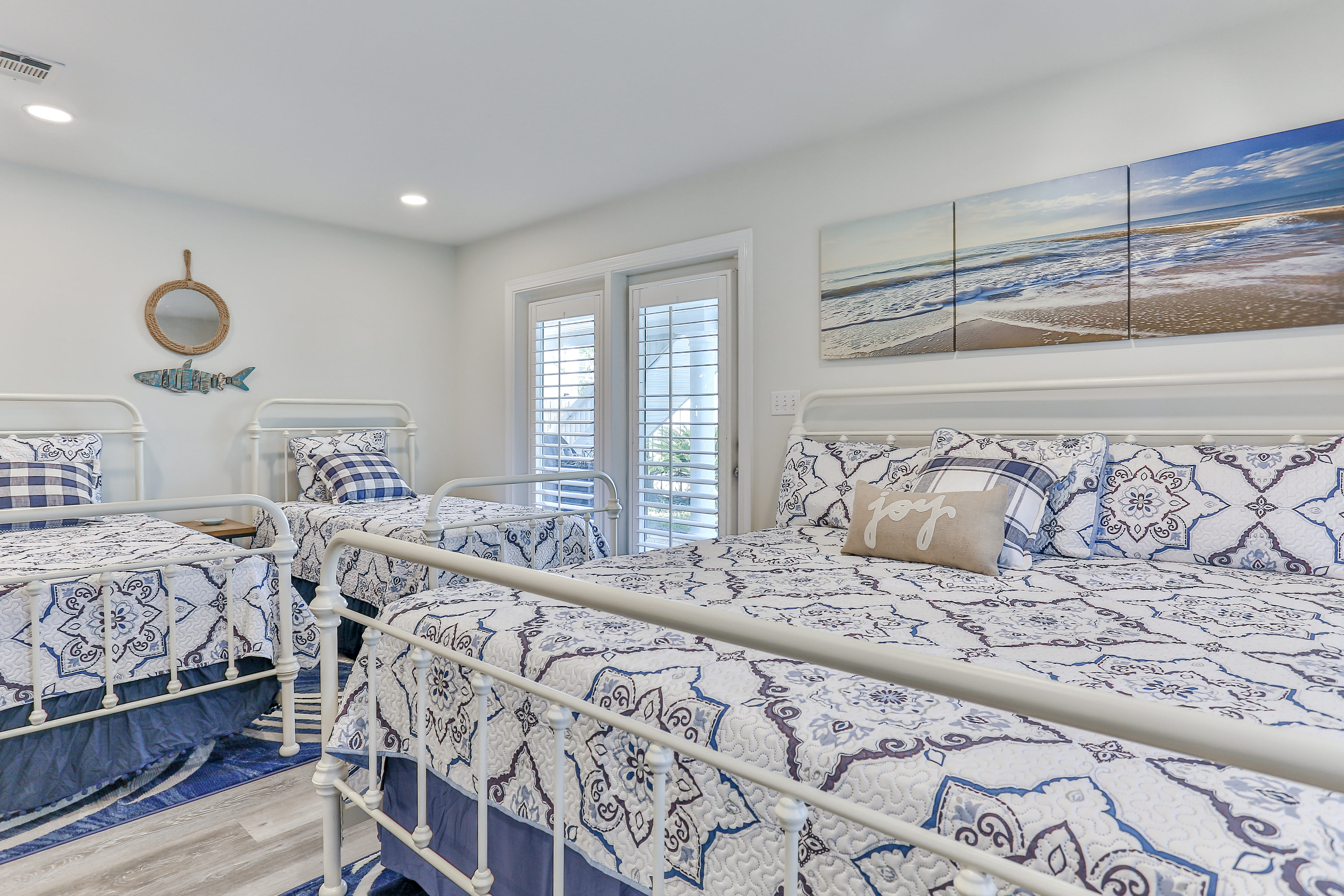 1st floor bedroom with twin over dbl bunk, 2 twins, one king bed. Door to pool.