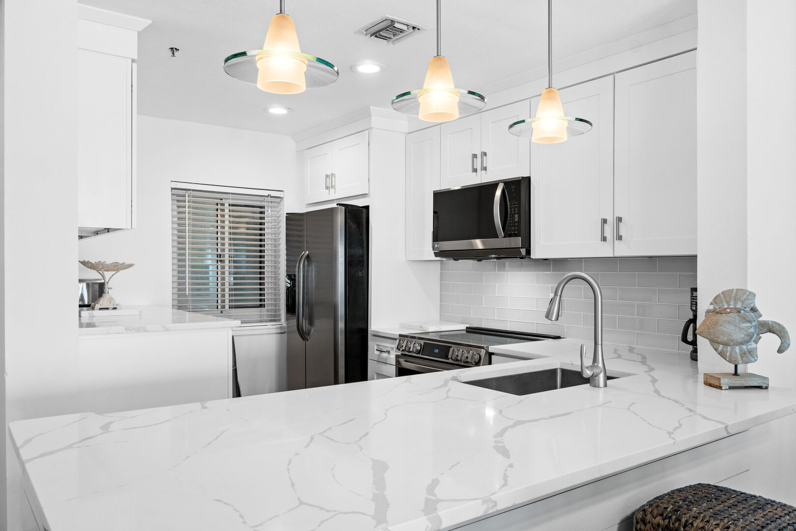 Bright and roomy kitchen to prepare your favorite meals. This updated kitchen provides you with all the necessities you need for any meal. There is a full size washer and dryer in the kitchen for your convenience.