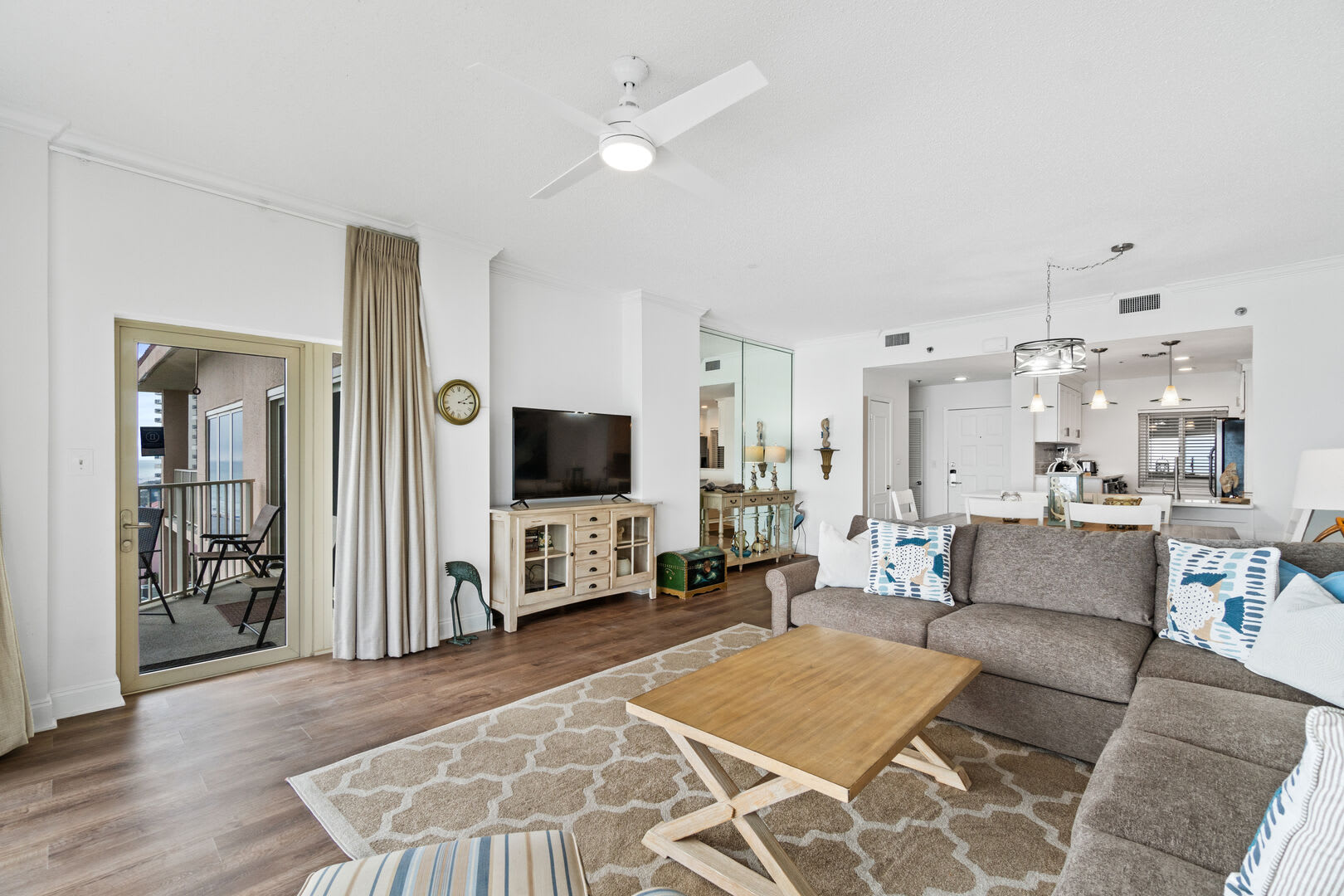 Different view from the living room into the dining area and kitchen. Entrance to 8th floor balcony.