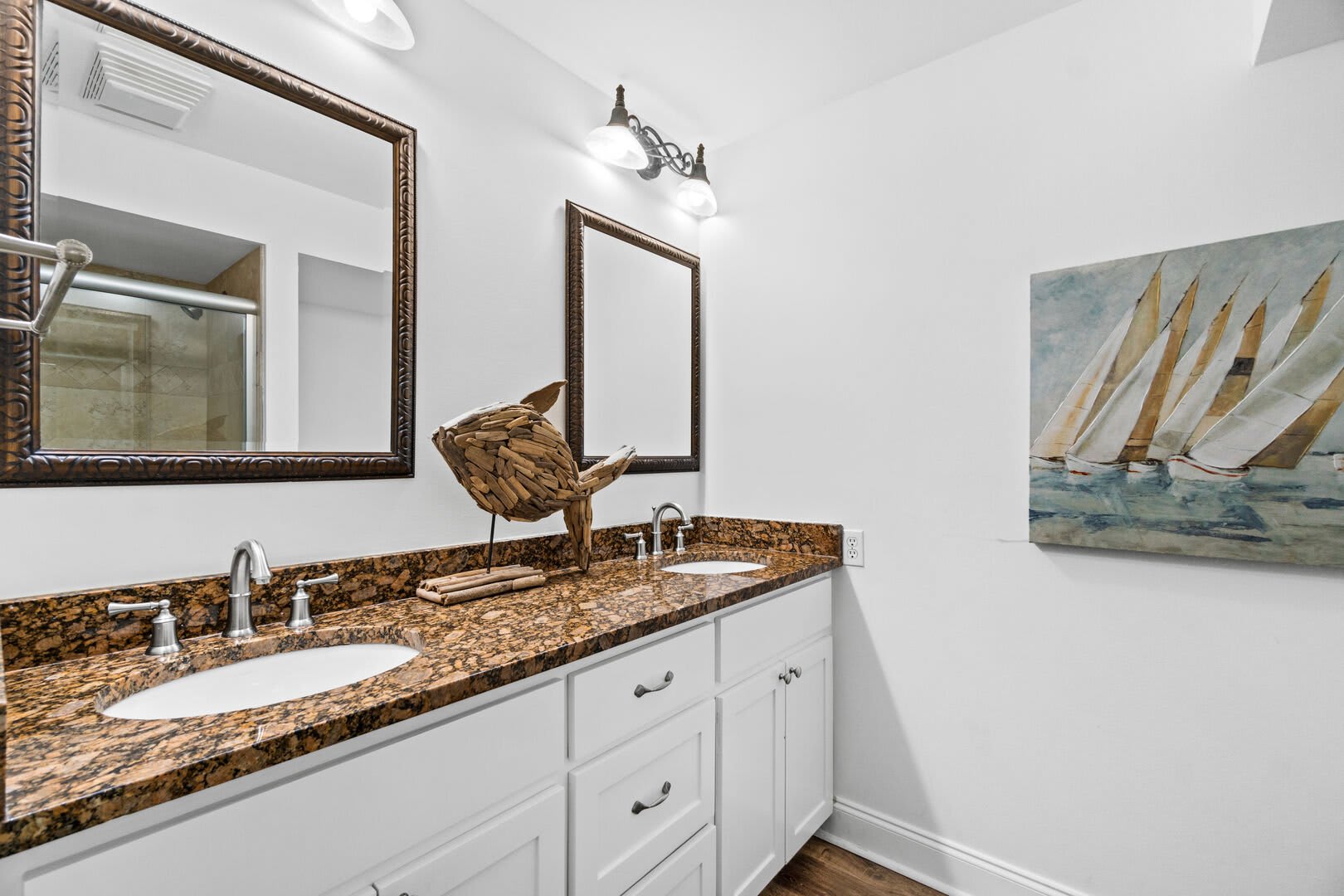 In the Master Bath you have a double vanity with 2 nice size mirrors and plenty of drawers and cabinets to keep all your bath & both supplies. It offers a tub/shower combo as well.