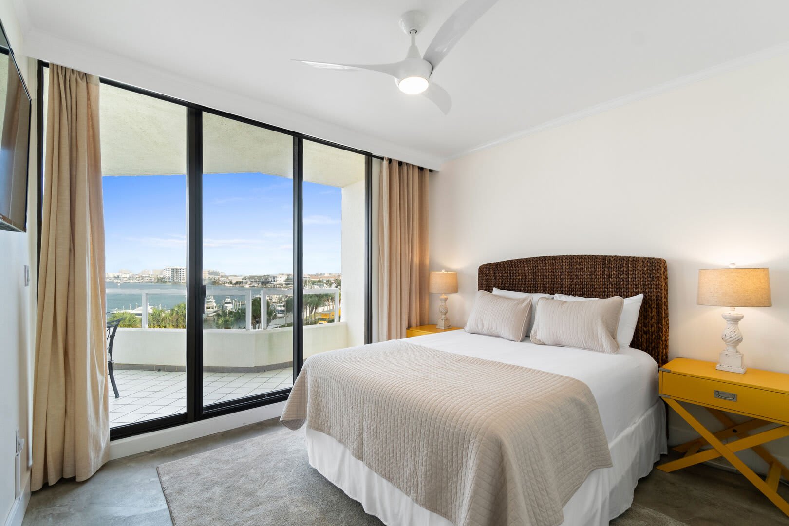 Queen bedroom with plush pillows and mattress with two side tables and lighting to nestle in after a long day of sun and fun.