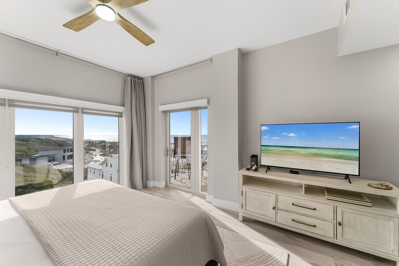 Master has a large screen TV, private balcony entrance, and dresser.