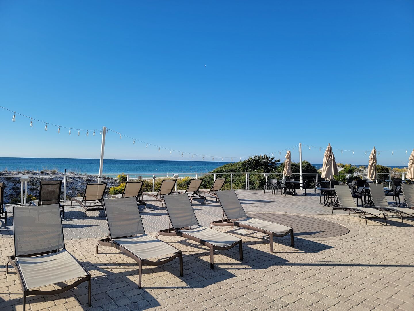 Large patio and sundeck with plenty of chaise lounge chairs for a day at the pool.