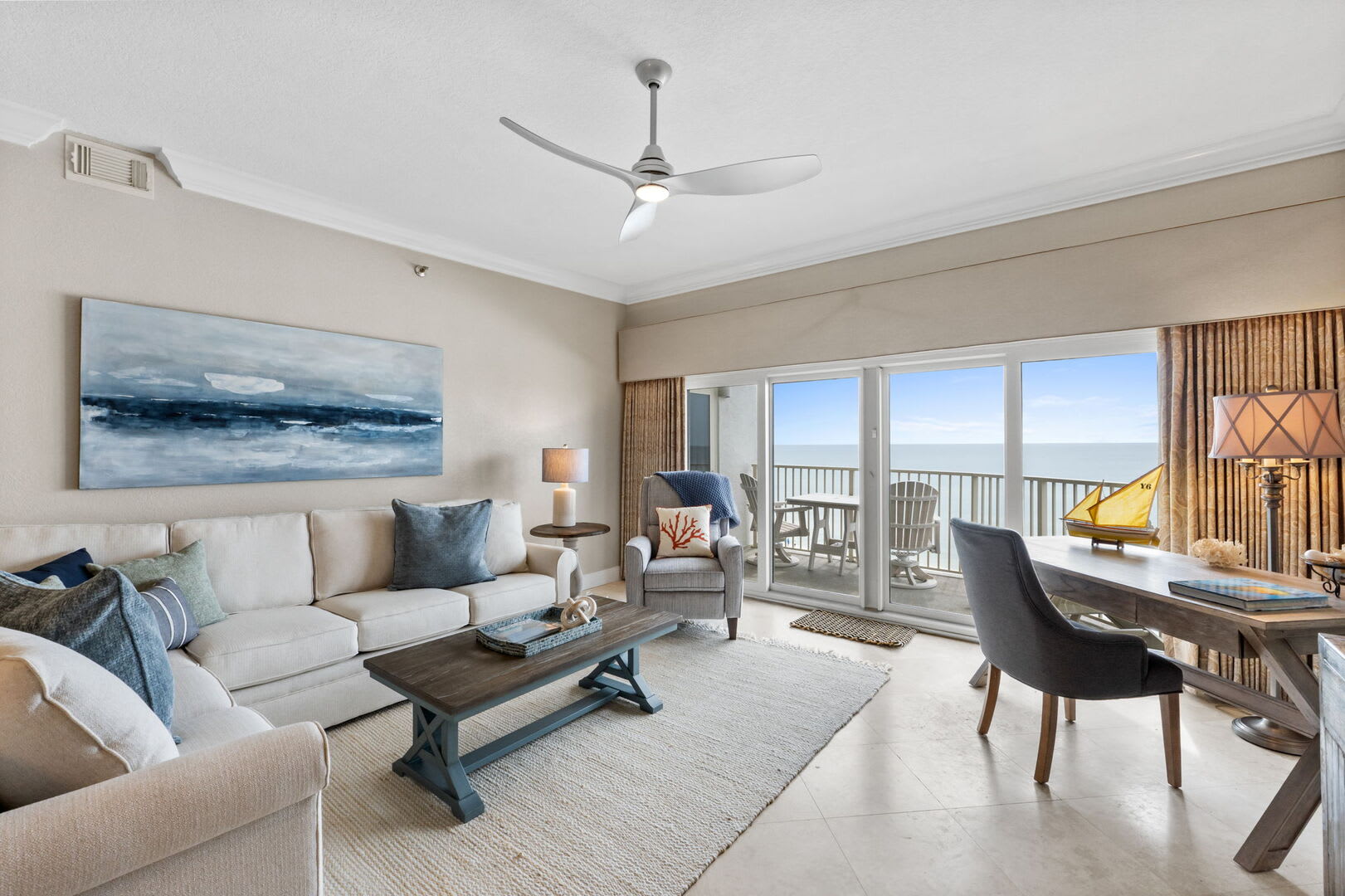 Living room provides plenty of plush seating for all your gathering as well as a full size desk for catching up on any work if you so desire.