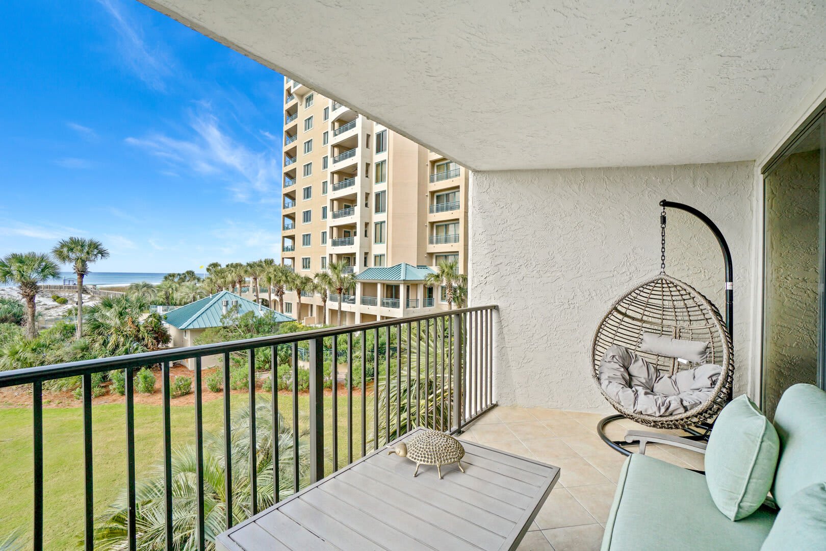 View from your 3rd floor private balcony. Two person setee and a cozy wicker bubble swing. Looks so inviting to curl up with a good book.