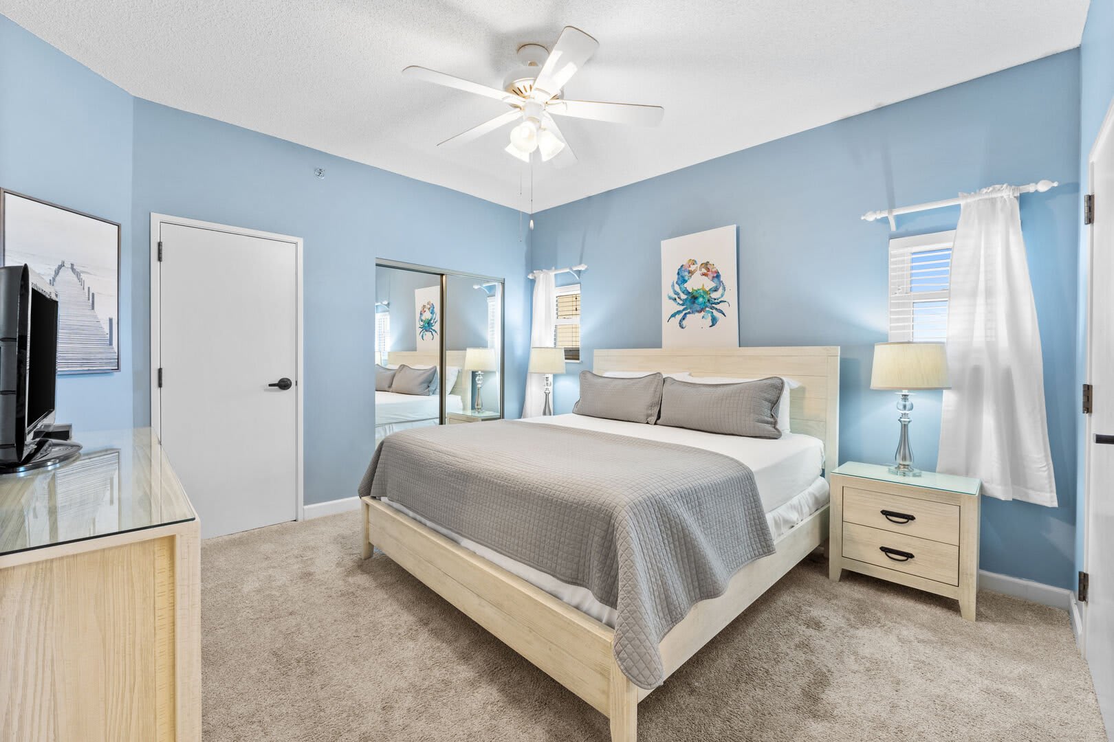 The master suite is a comfortable retreat after a day of beach activities.  Sink into the plush king size bed with crisp while linens and soft pillows and get ready for a great night's sleep. There are 2 bedside tables & lamps. A double size closet and a 