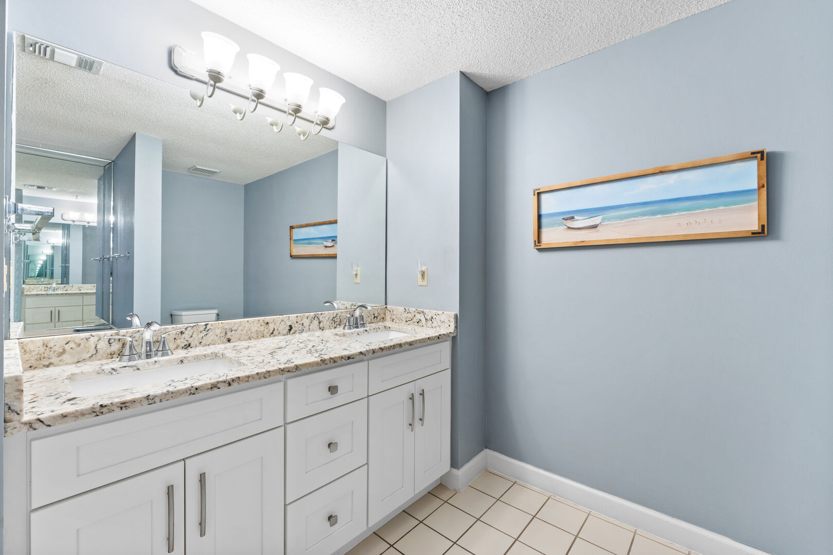 Two sink vanity, full mirror and plenty of counter and storage space.