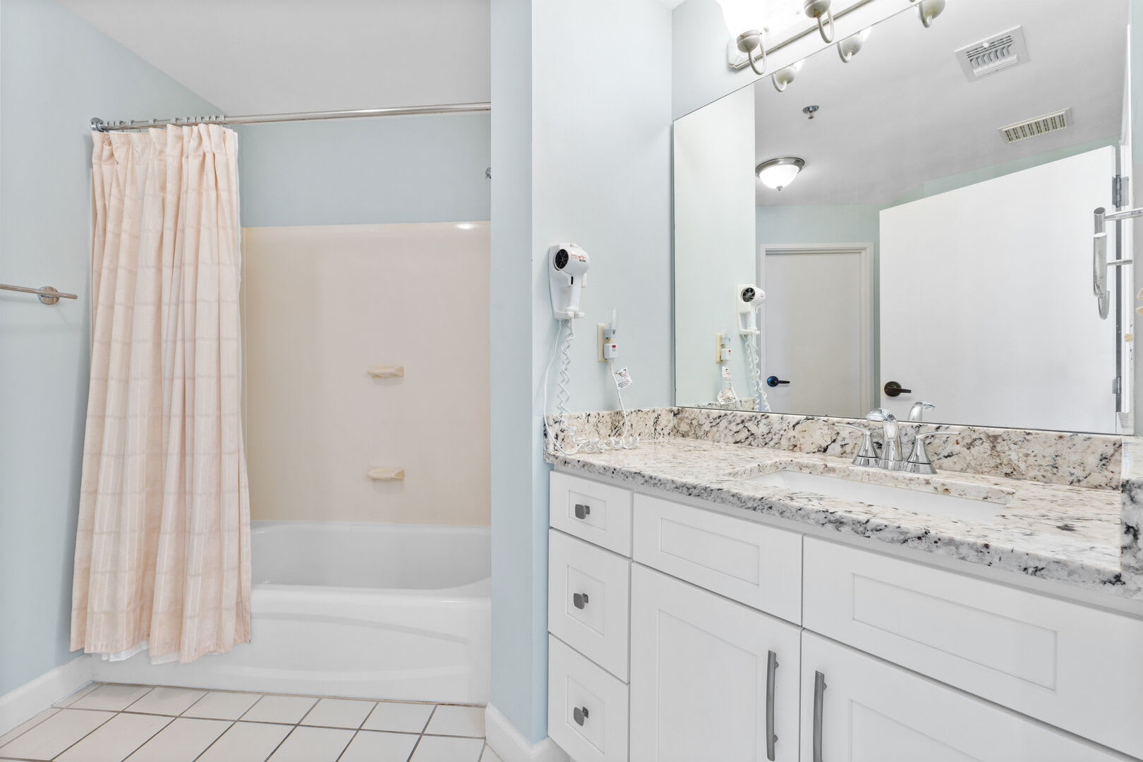 Gust bath with single sink vanity, and full mirror. Pleaty of storage and counter space