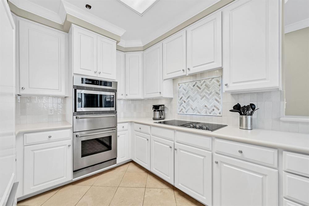 Updated kitchen features plenty of quartz counters and cabinet space.