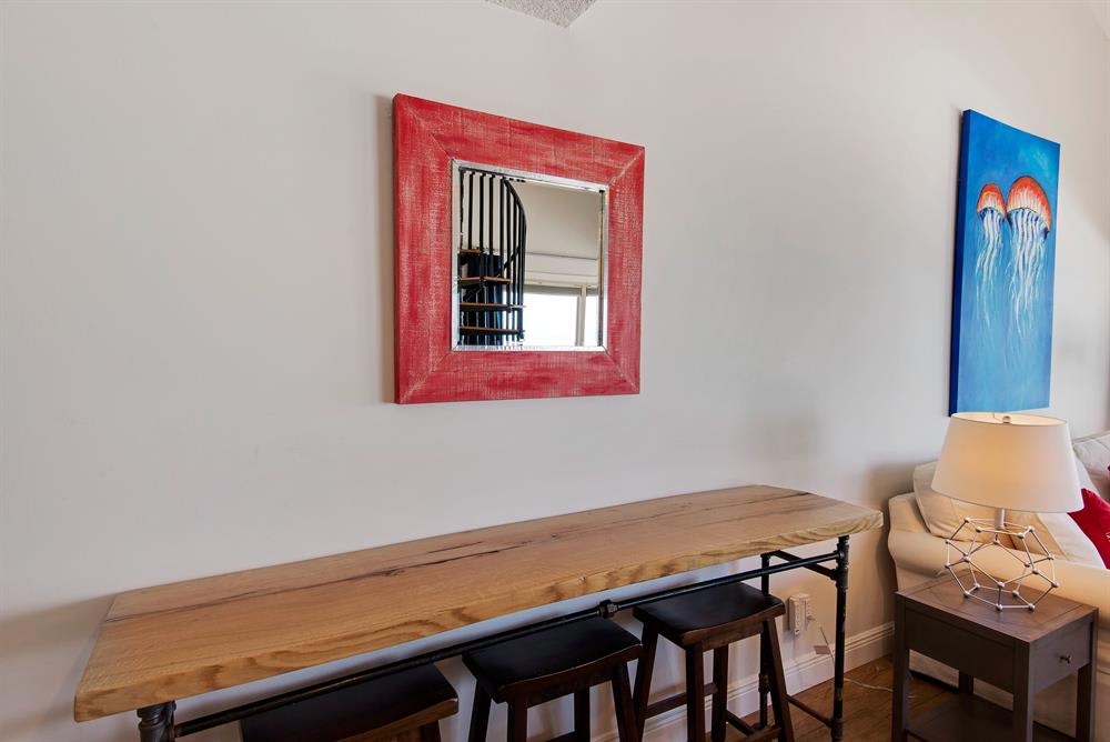 Custom-made natural edge table with bar stools, perfect for casual beach dining.