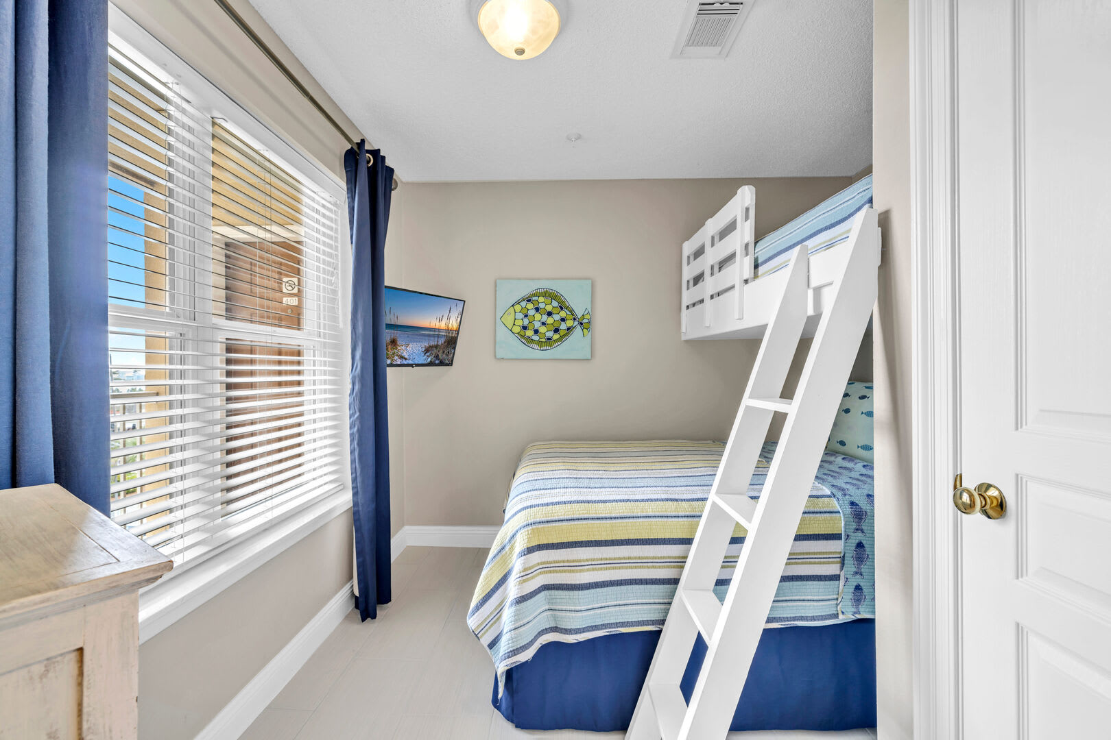 3rd Bedroom featuring a queen bed, twin bunk, smart TV and a closet.