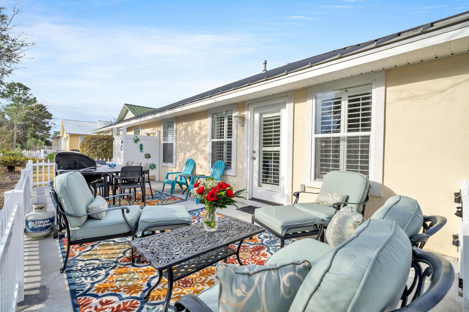 Comfortable fenced patio with seating & dining areas + private outdoor shower.