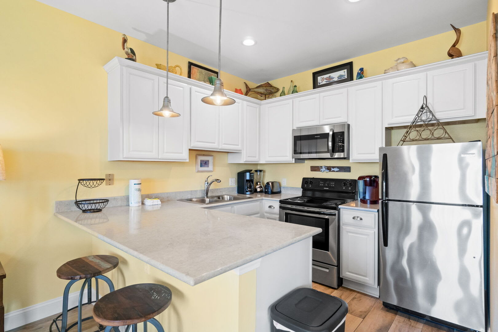 Bright kitchen opens to dining and living areas with Gulf views.