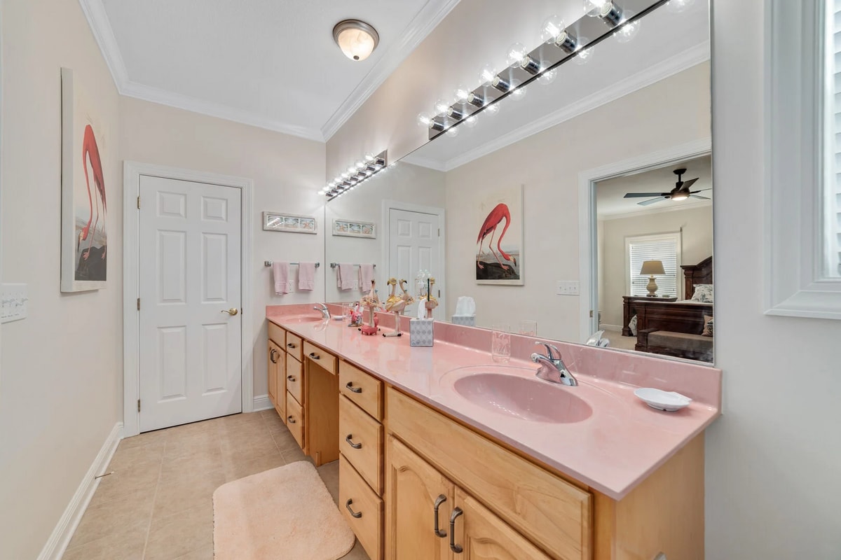 The private bathroom is charmingly decorated "flamingo style" and offers a double vanity for spacious convenience.