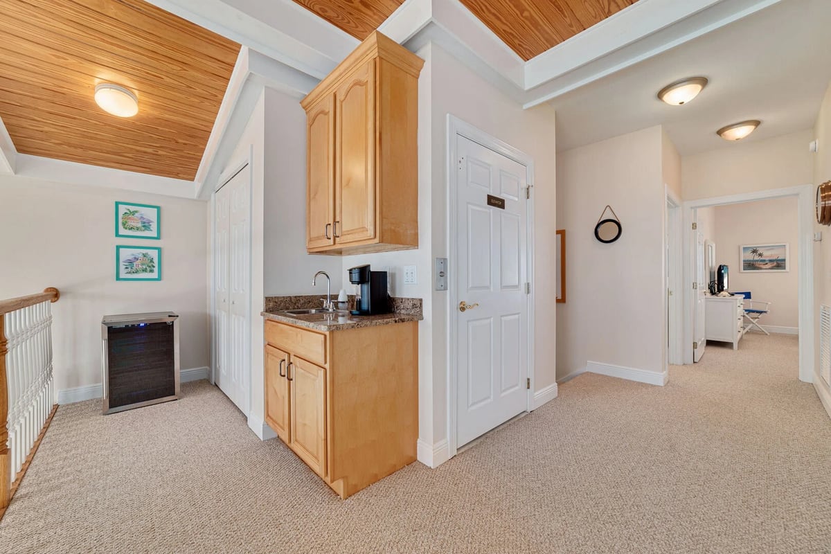 The upstairs loft is equipped with a mini fridge, coffeemaker, and wet bar area for your added enjoyment.