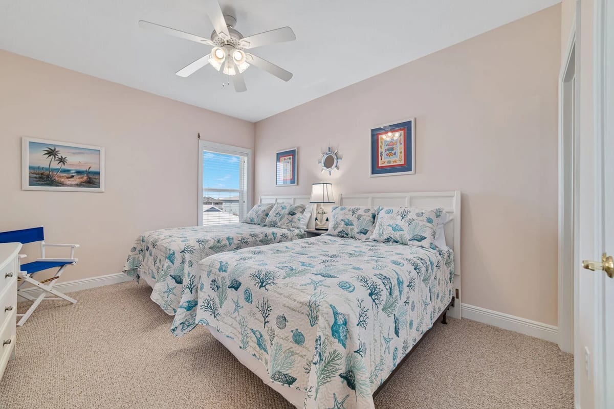 Upstairs, this guest bedroom features two full size beds to maximize sleeping accommodations.