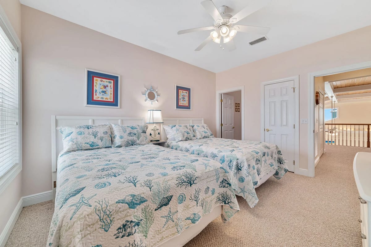 Soft linens and plush mattresses promote restful slumber in this cozy nautical-inspired retreat.