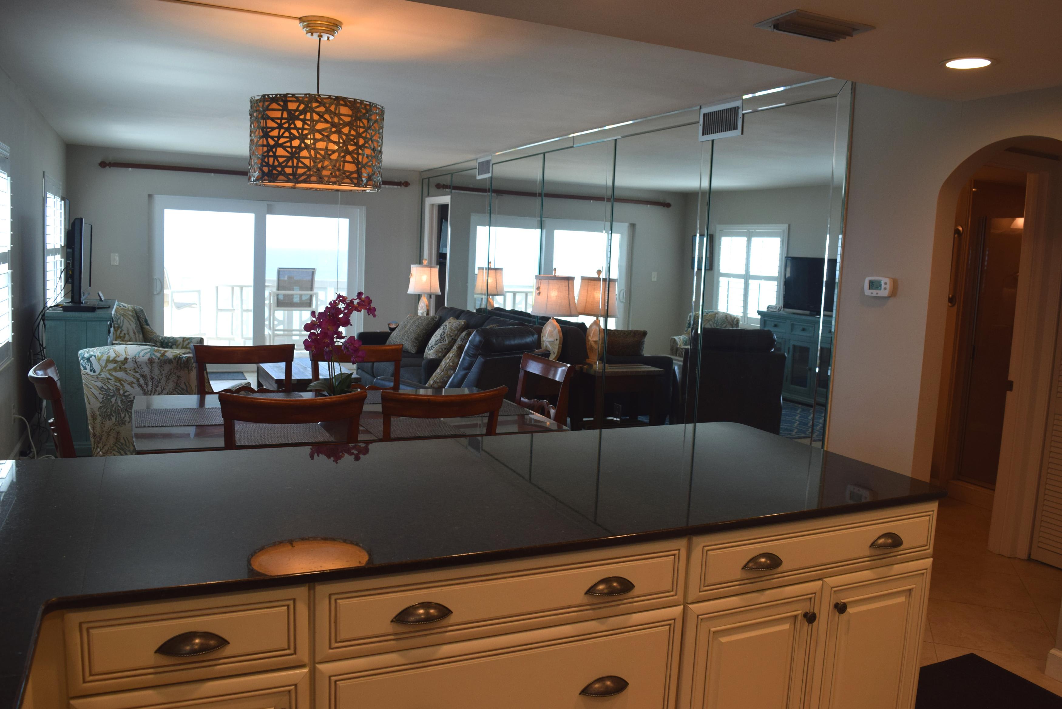 Looking across the low bar separating the kitchen and dining area - with the beach beyond.