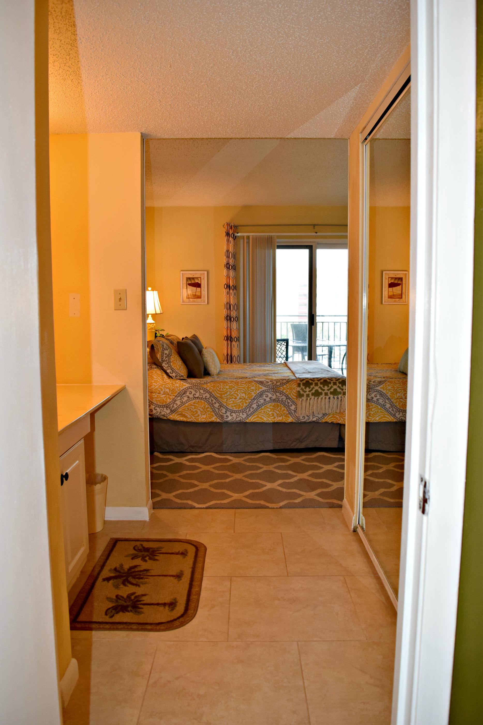 From the bathroom, through the vanity area to master bedroom.