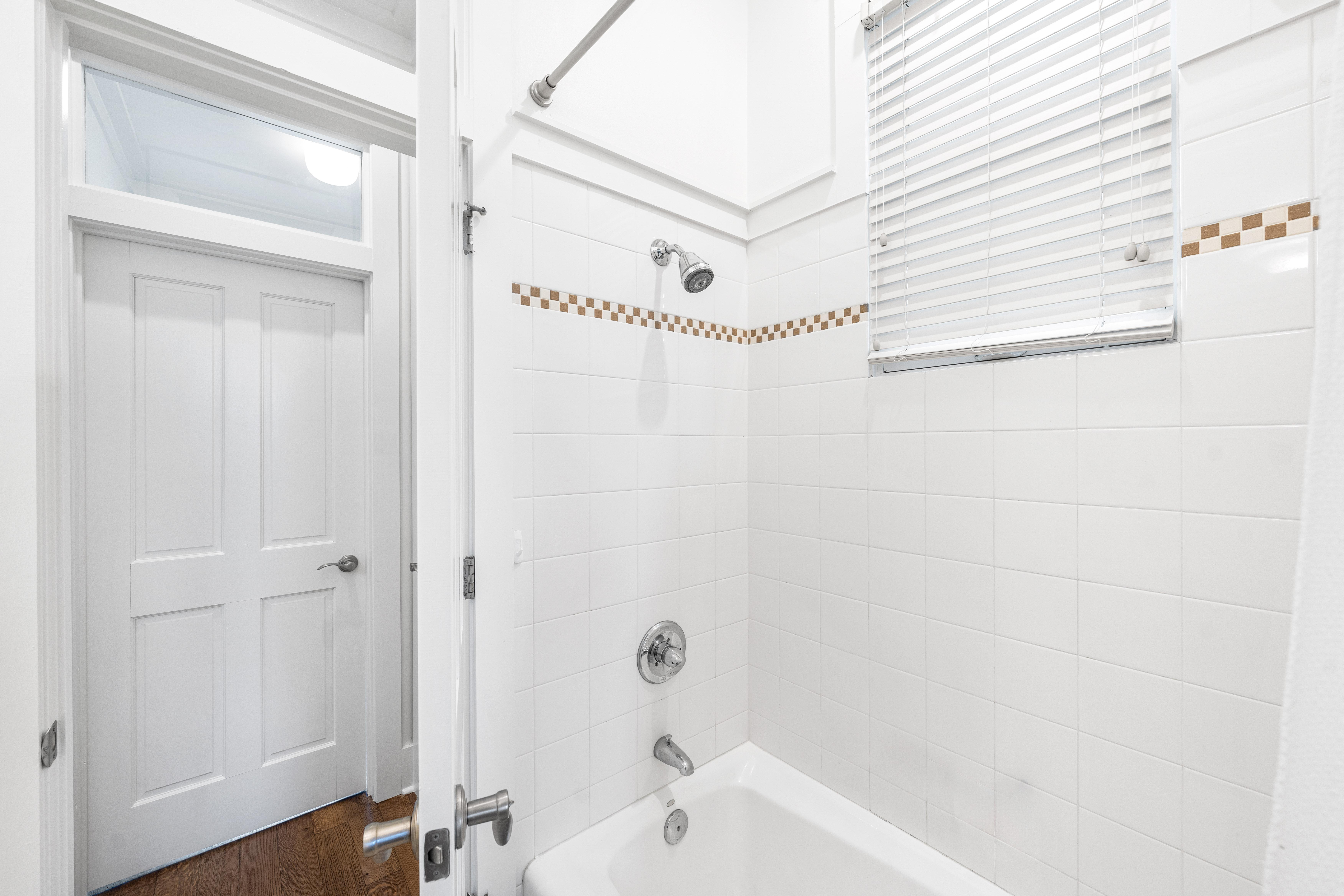 Full Bathroom with Bathtub/Shower Combination in the 1st Floor Bedroom with Queen Bed, with 32" YouTube TV.  This bathroom can also be accessed from the hallway.