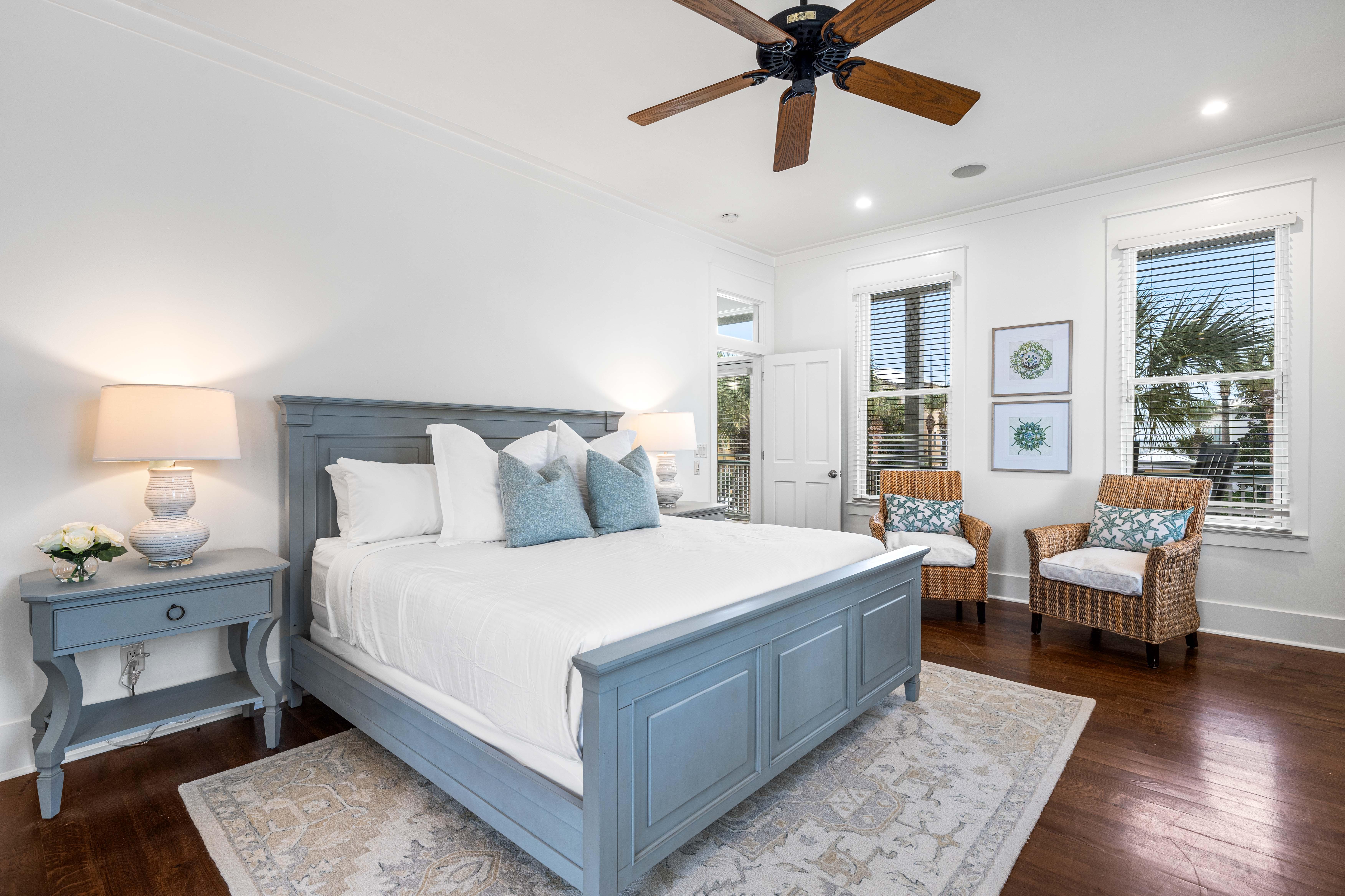 2nd Floor Primary Bedroom with King Bed, 40" YouTube TV, Desk, Walk-in Closet, Ensuite Full Bathroom with Separate Soaking Tub, Walk-in Shower, Double Vanities, & Access to the Covered Balcony with Bistro Tables.