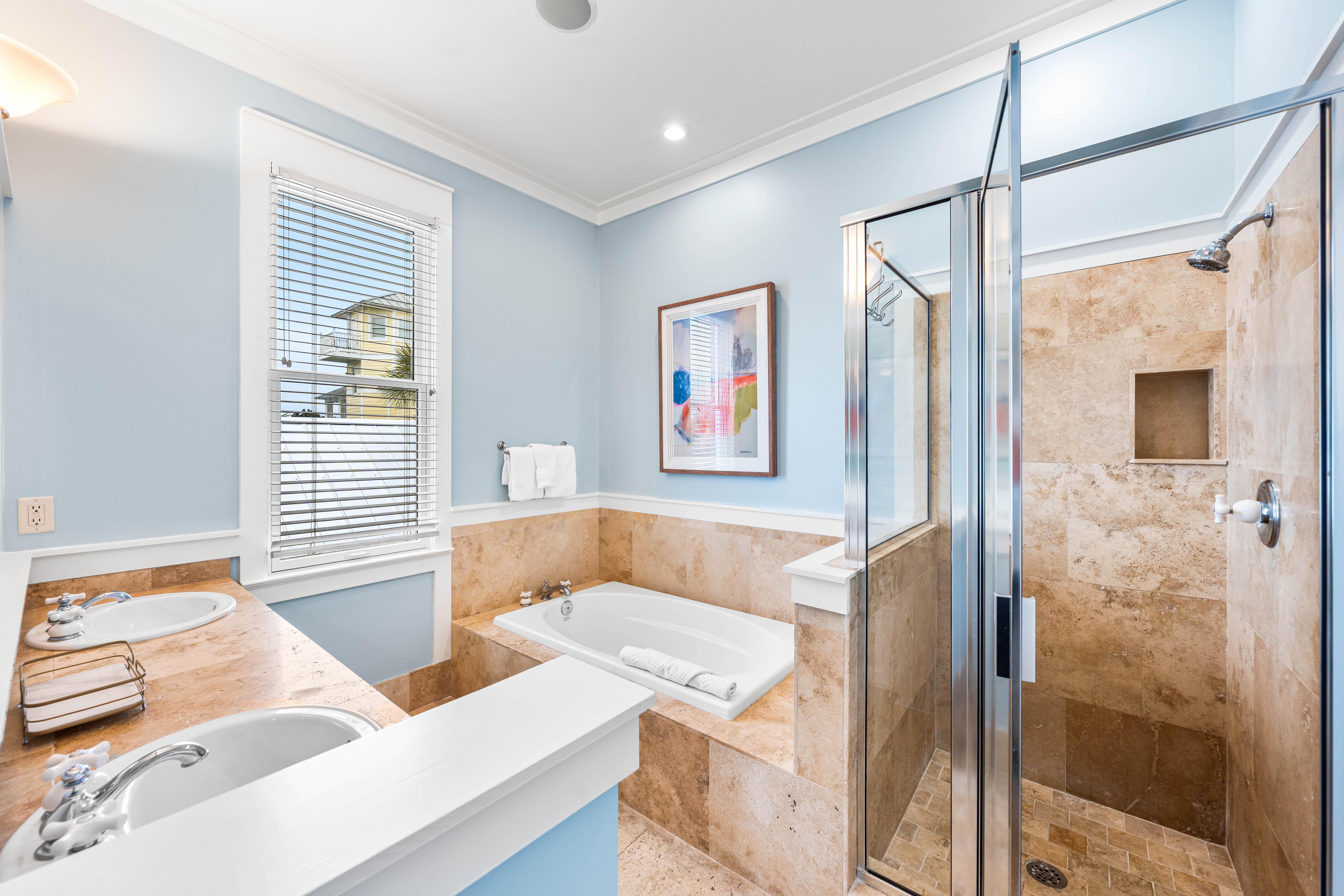 Primary Ensuite Bathroom for the King Bedroom has Soaking Tub, Walk-In Shower, Double Vanities, & Water Closet.