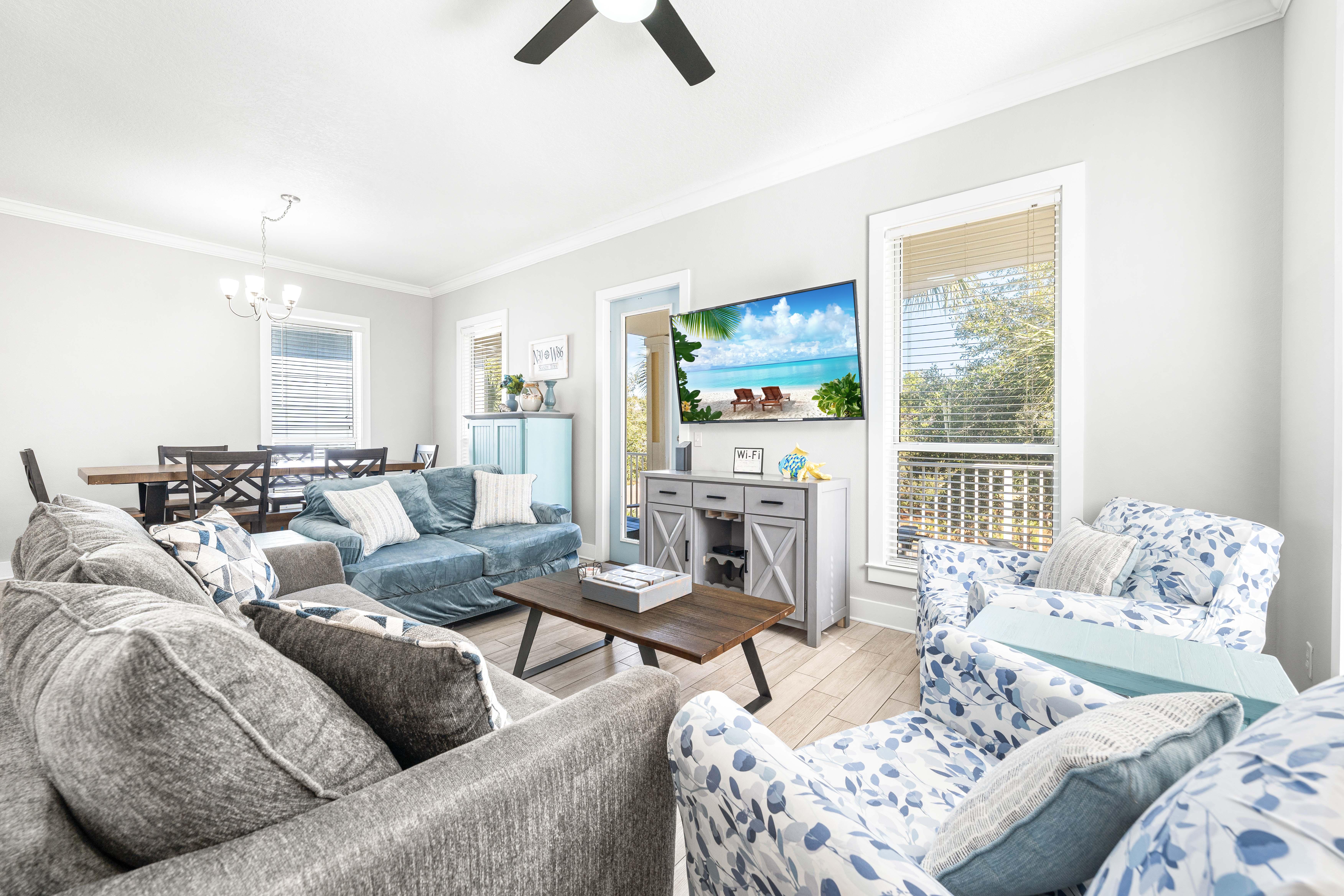 Open floor plan in this 2nd floor main living area with a new sleeper sofa and a 65" smart tv.  Large collection of DVDs for the DVD player!  There's also a balcony with seating for morning coffee or evening cocktails just off the living room overlooking 