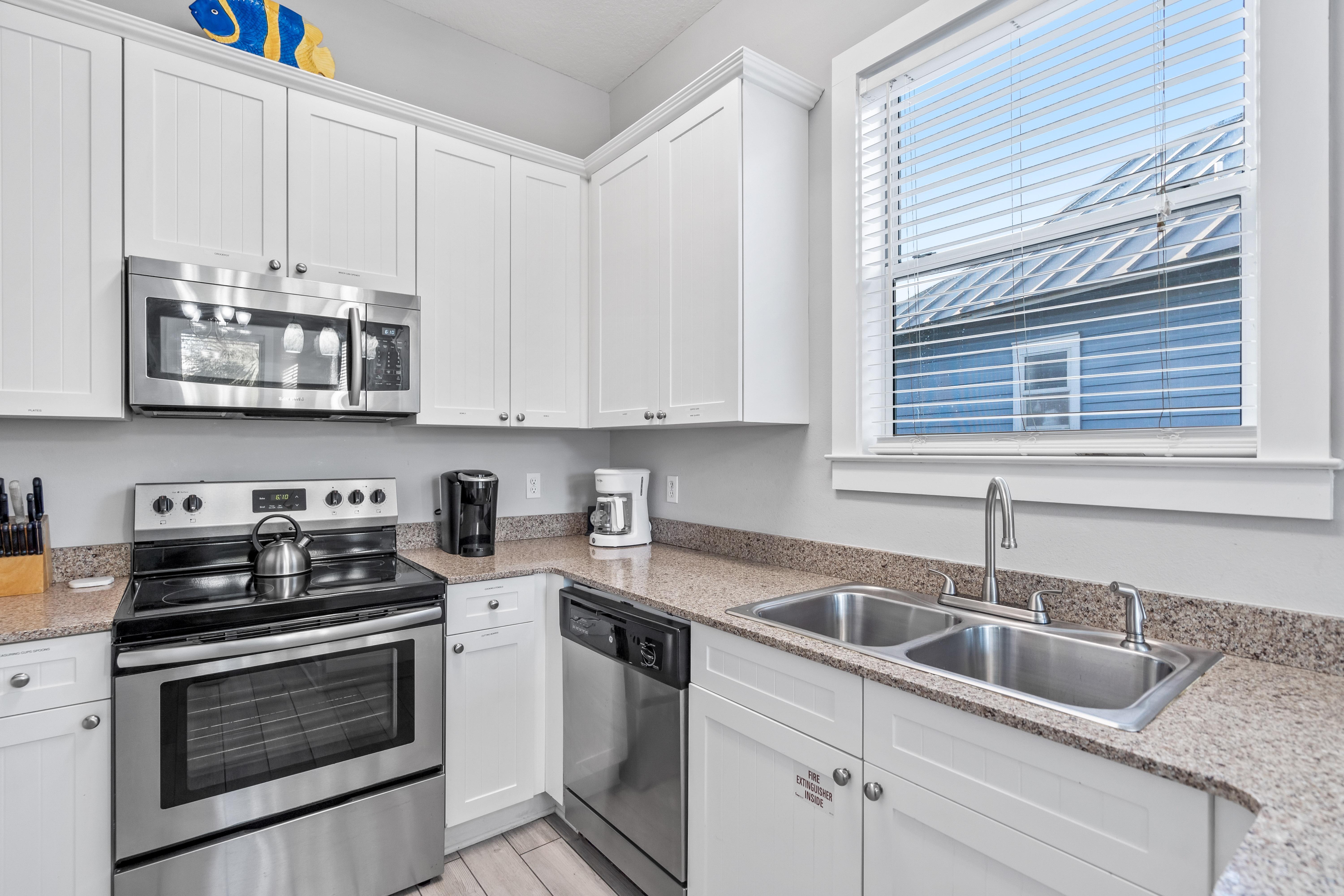 Fully Stocked Kitchen with Stainless Steel Appliances and Bar Seating for 2