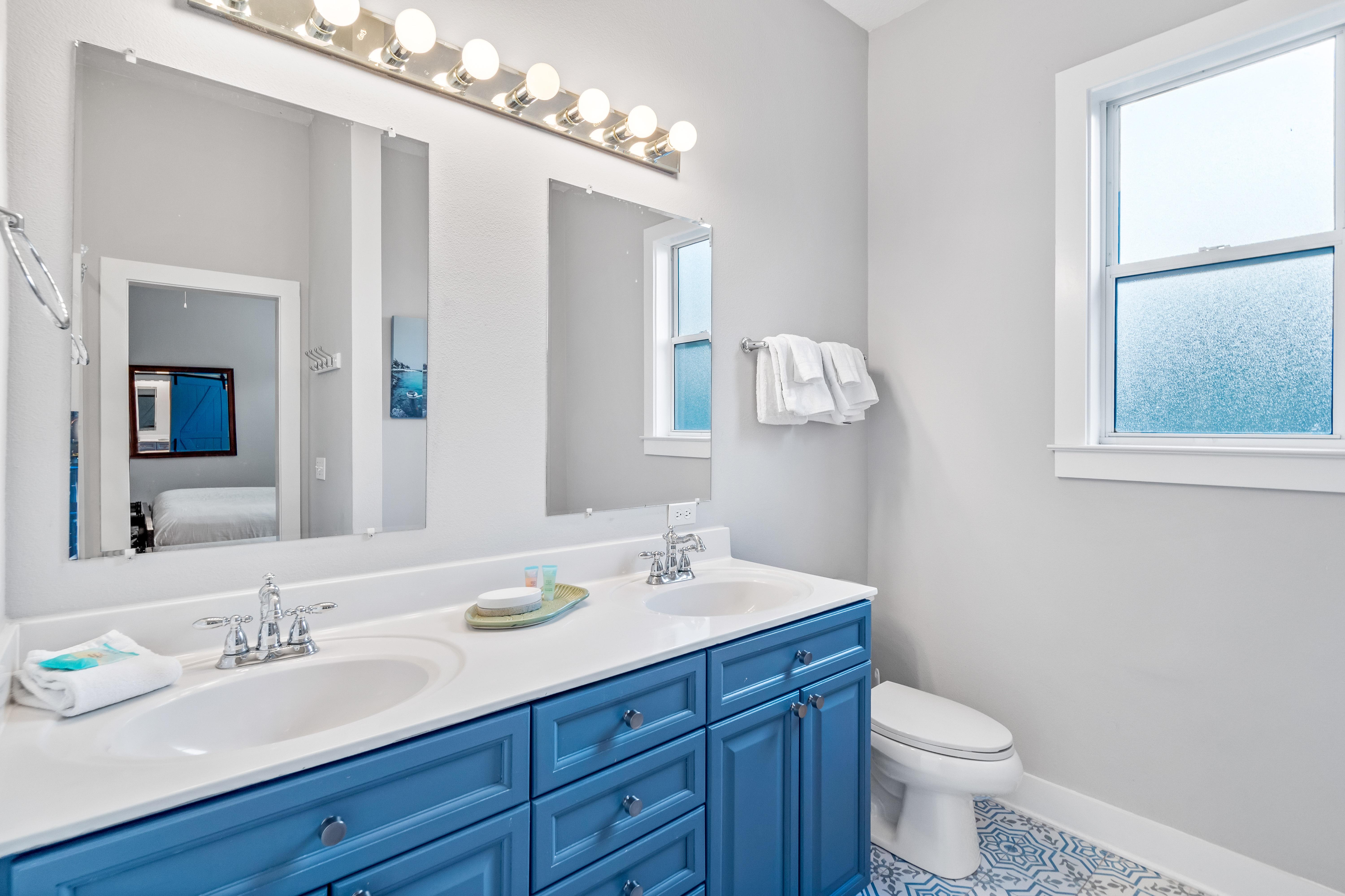 2nd floor ensuite bathroom for the primary king bedroom with double vanities, separate walk-in shower & soaking bathtub.