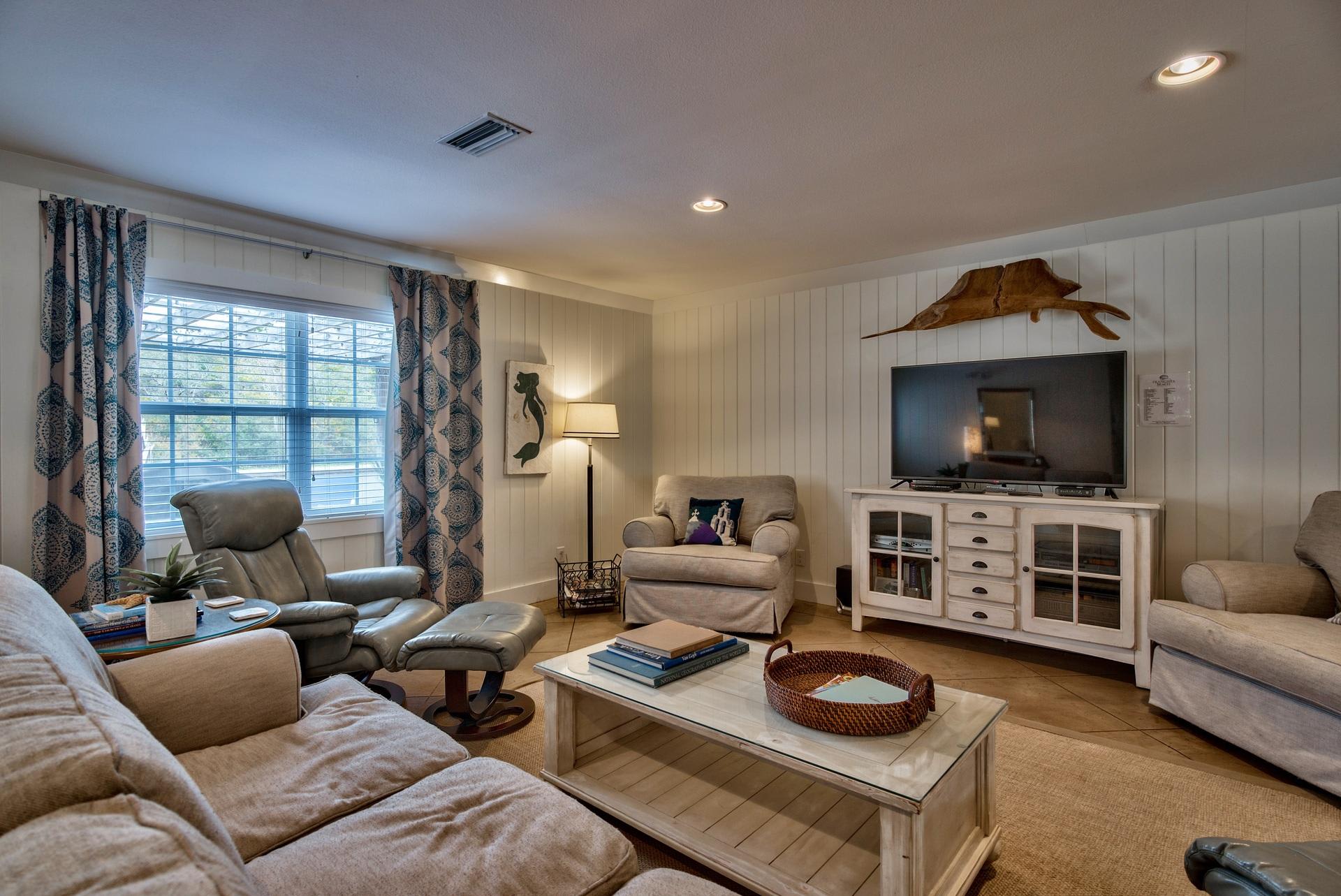 Open Concept Living Area With Sleeper Sofa, 50" TV, Plenty of Space for Family Gatherings, and a Pac Man Game Arcade.