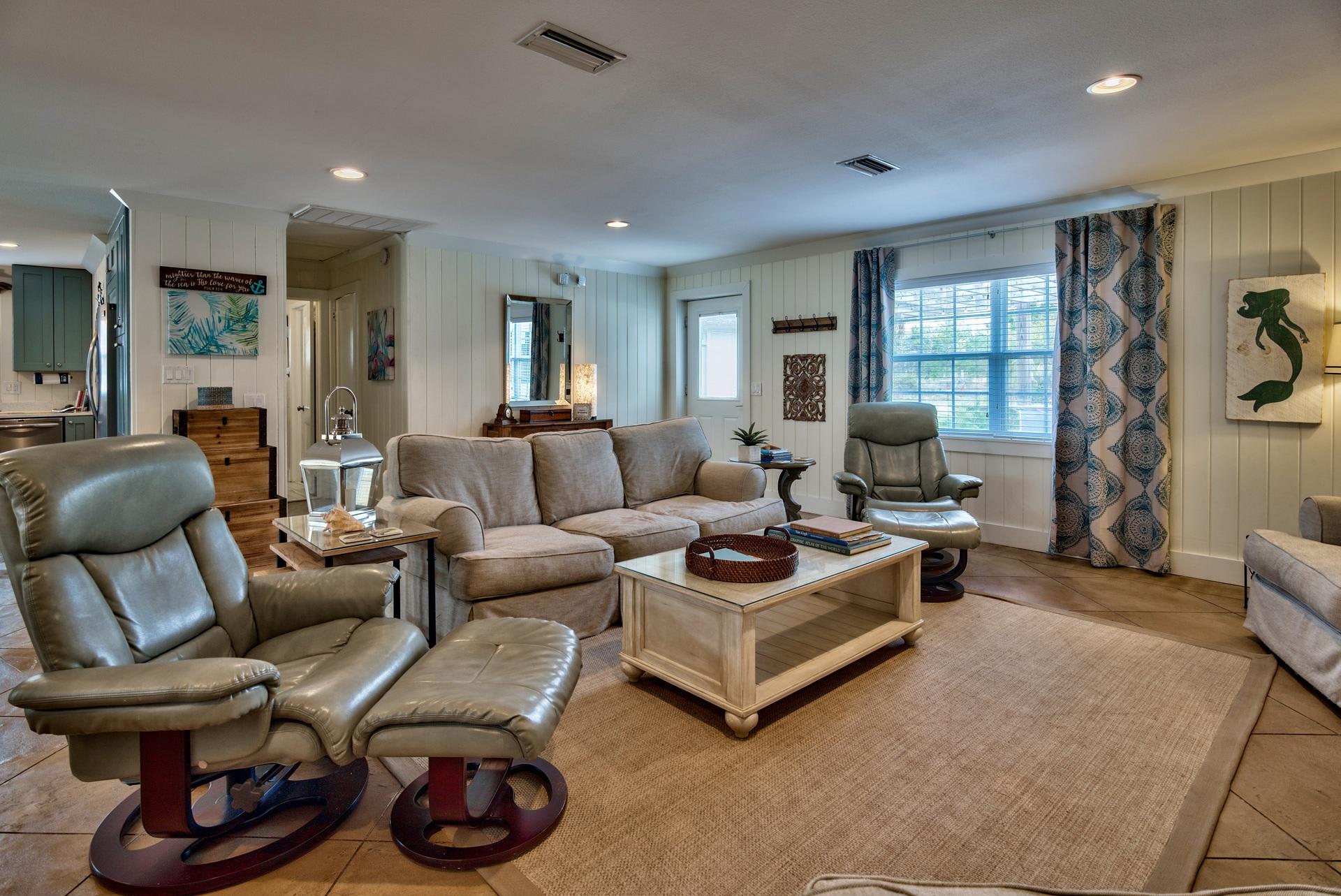 Open Concept Living Area With Sleeper Sofa, 50" TV, Plenty of Space for Family Gatherings, and a Pac Man Game Arcade.