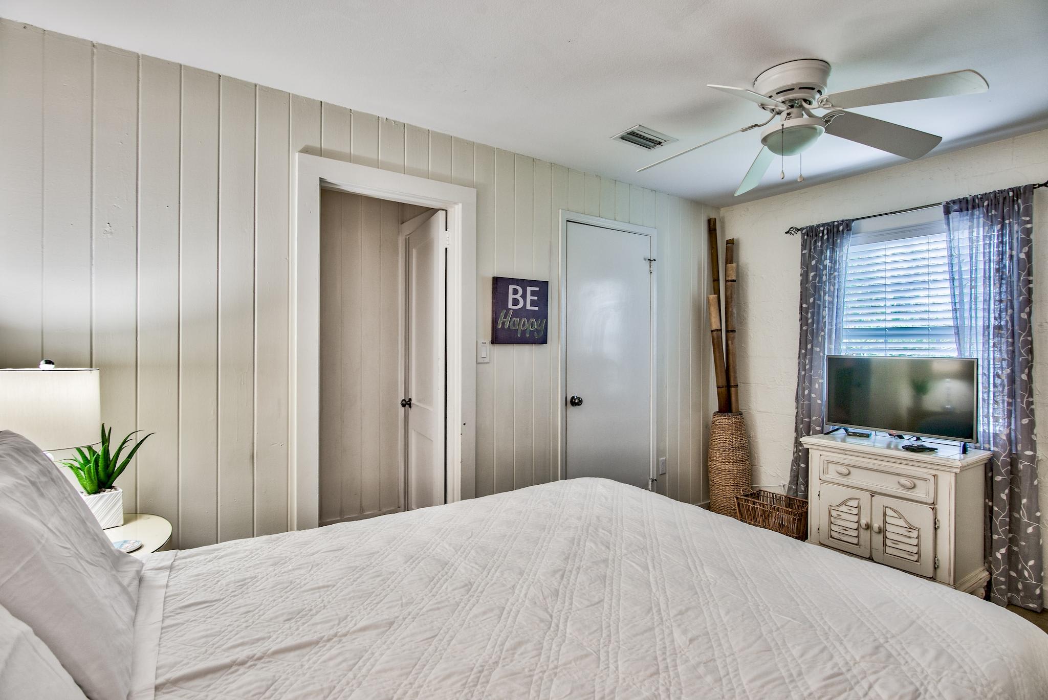 First bedroom on the west end of Seabreeze with queen bed, walk-in closet, & adjacent full bathroom with walk-in shower