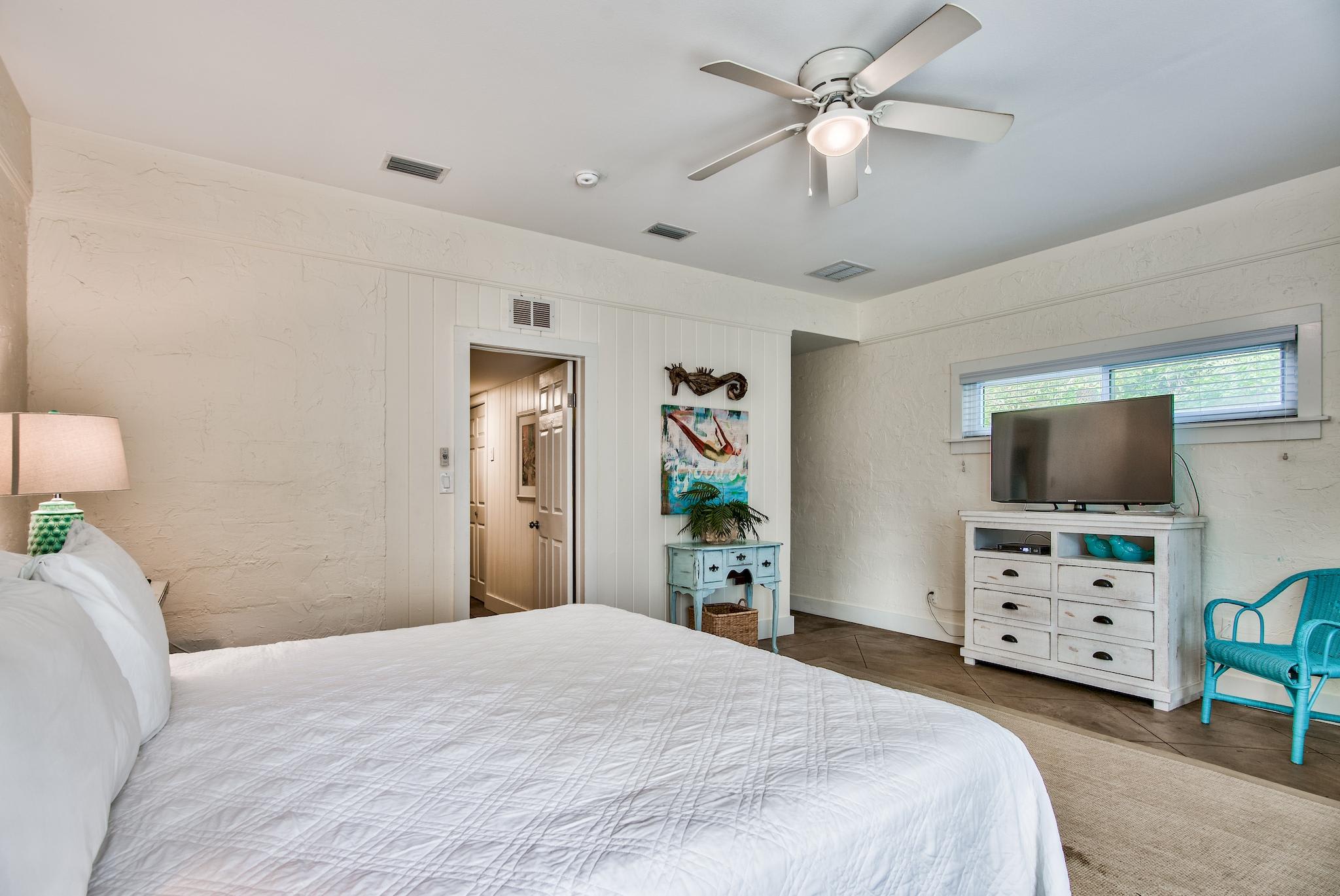 3rd Bedroom is the primary suite on the east end with a king bed, 45" TV,  walk-in closet, ensuite full bathroom with a bathtub/shower combination, and views of the pool area & door leading out to the pool.  (safety alarm on door)