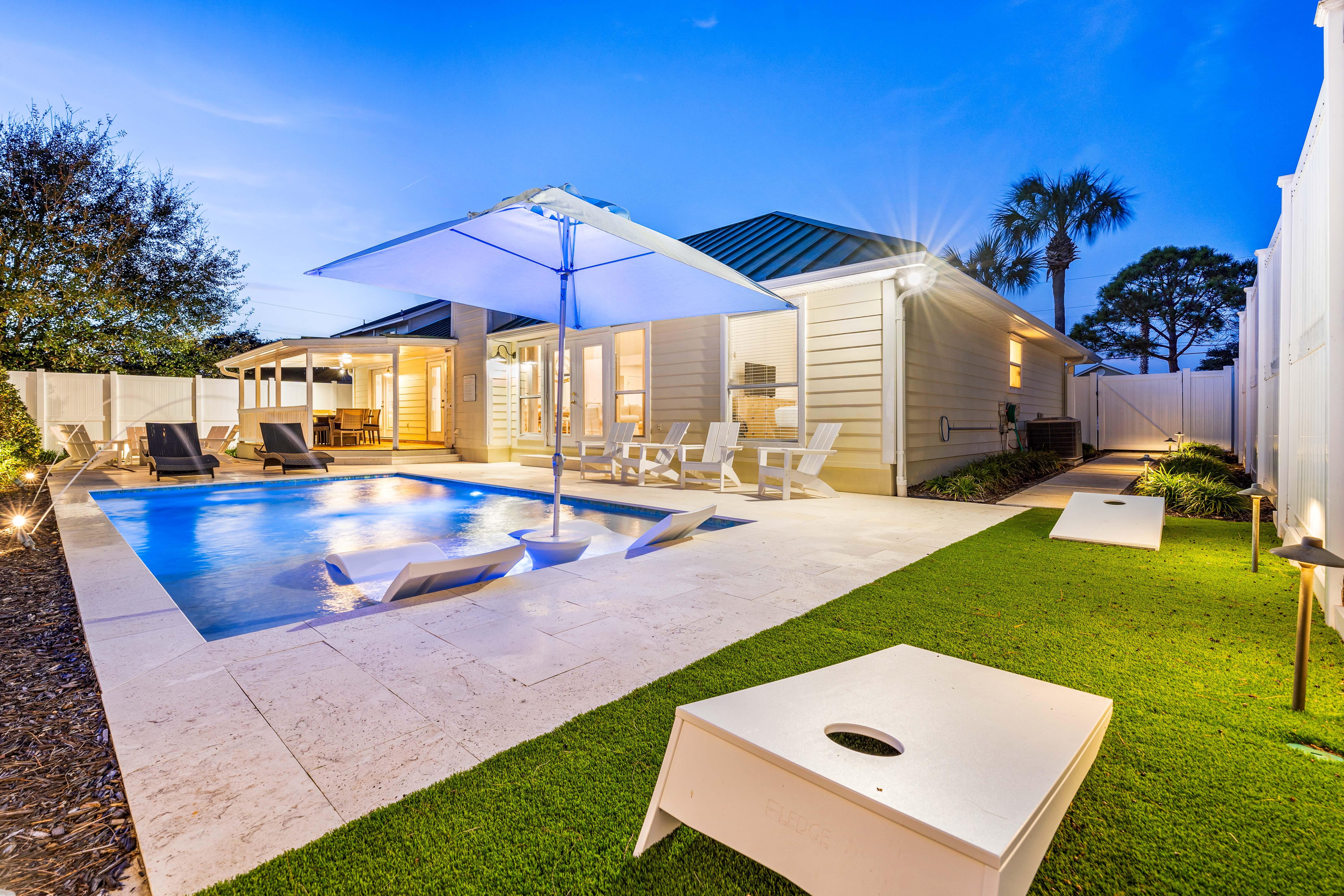 Large Private Pool with Sunshade, in Pool Lounge chairs!! Spacious Pool Deck with a Fire Pit and covered Dining Area!! This Backyard is Completely Enclosed, Corn Hole!!