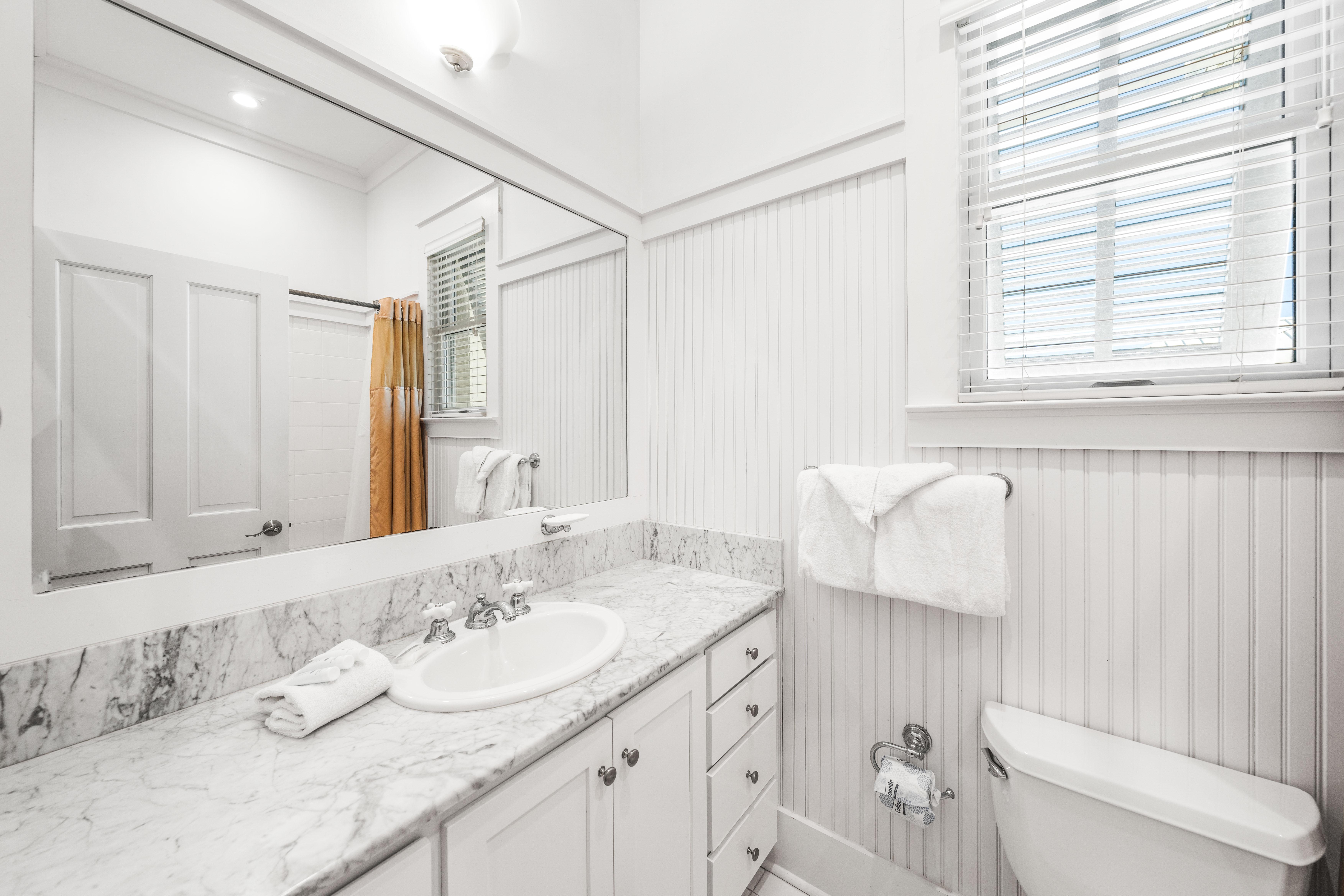 Ensuite bathroom for 3rd floor northeast queen  bedroom.  Marble vanity and bathtub/shower combination.