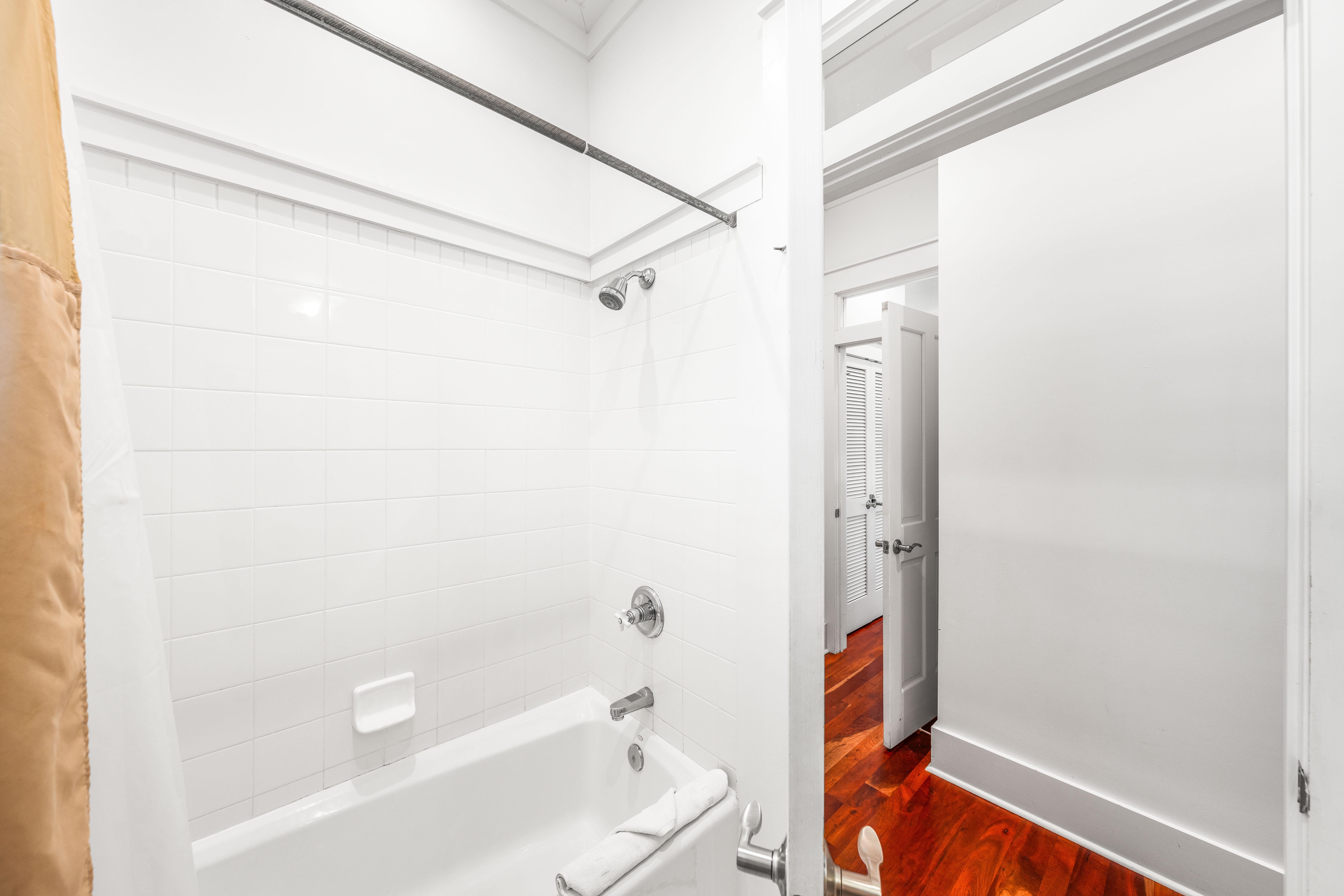 Ensuite bathroom for 3rd floor northeast queen  bedroom.  Marble vanity and bathtub/shower combination.
