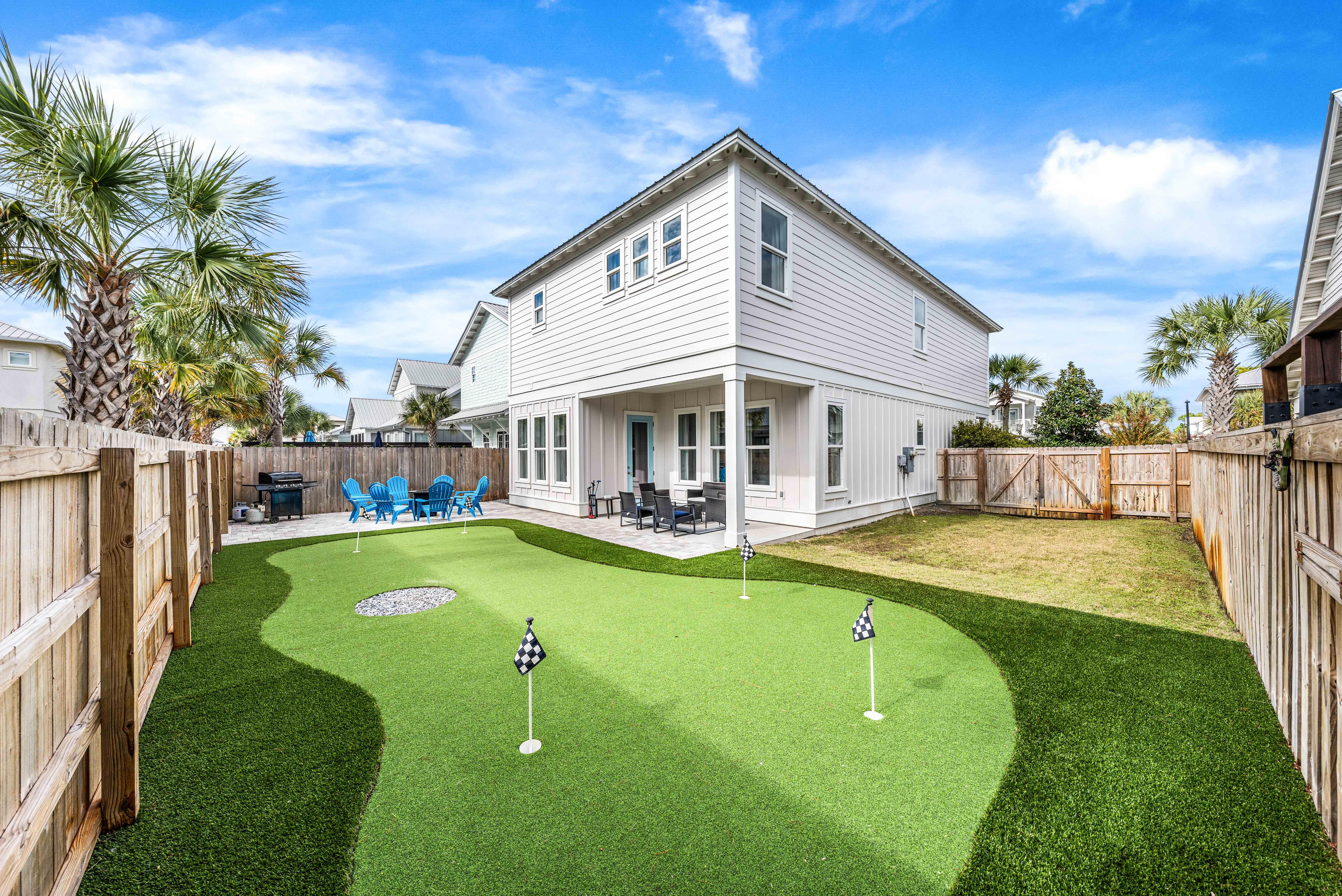 Relaxing fire pit with seating, propane grill, completely fenced in, large 5 hole putting green, putters & balls included, covered back porch with plenty of seating.