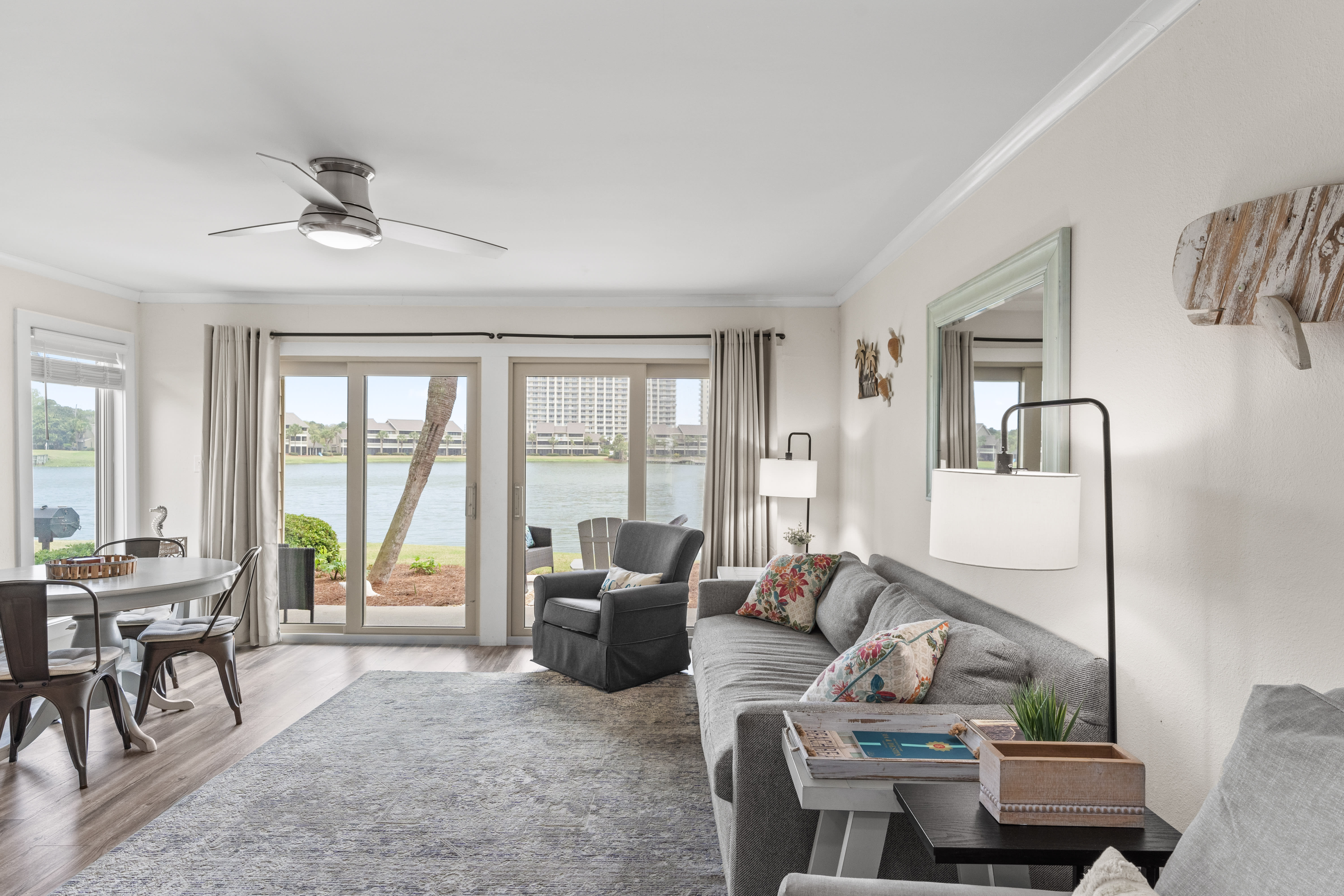 Unwind in your spacious waterfront living room with stunning lake views through floor-to-ceiling windows.