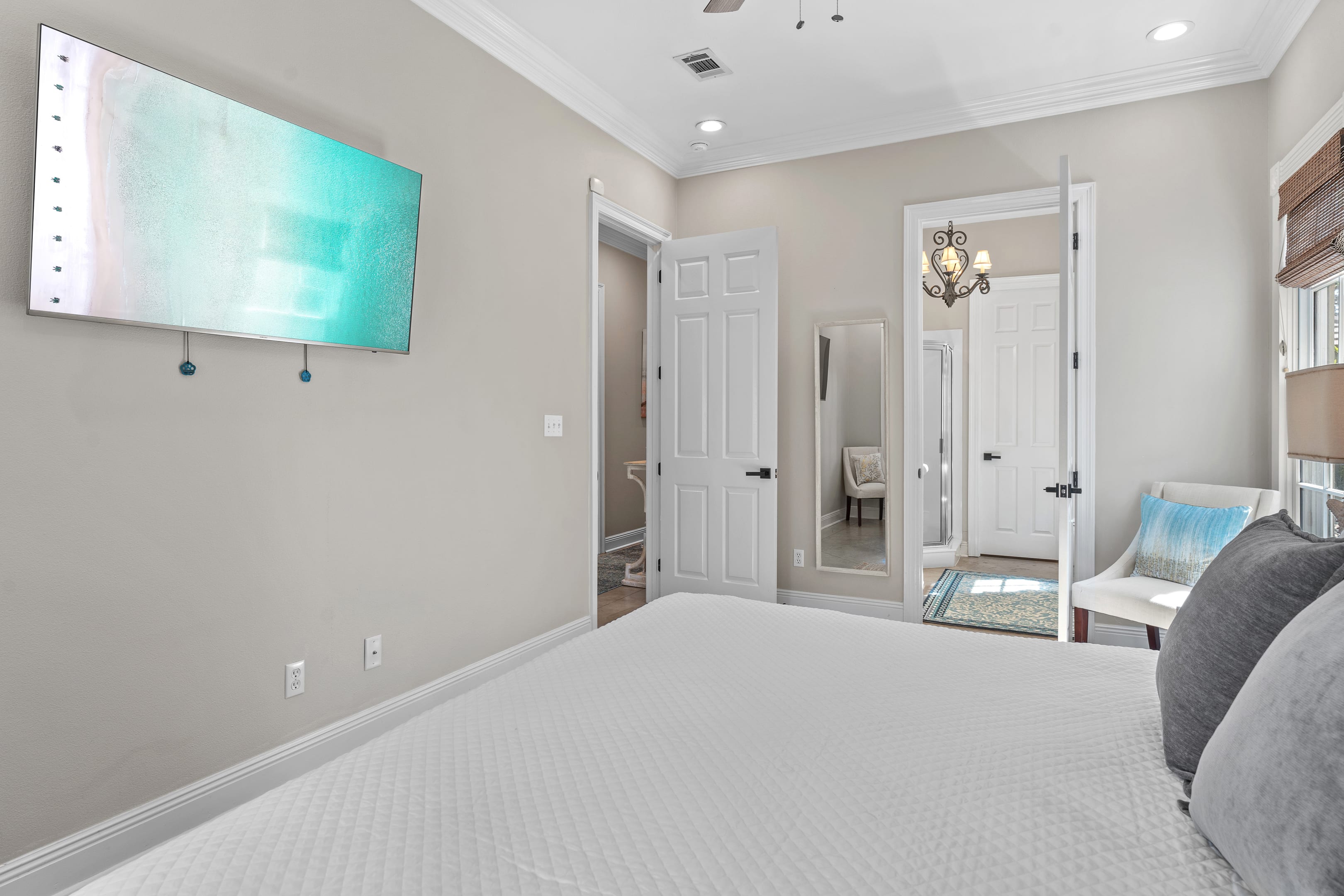 Primary bedroom with large screen television