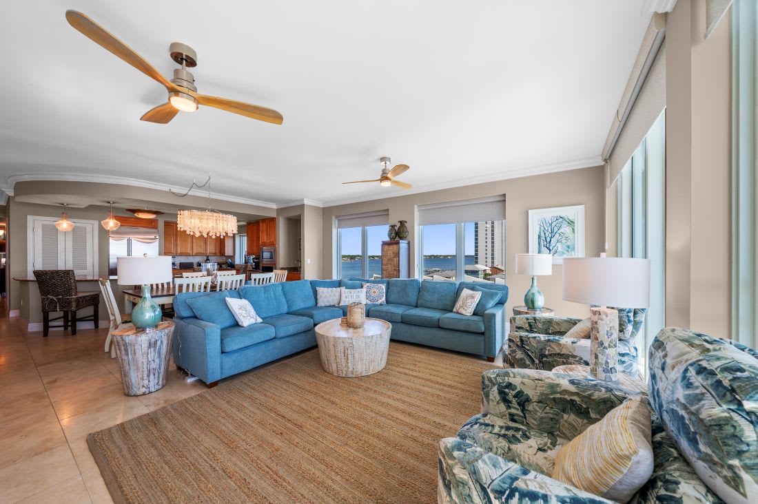 Relax in your bright coastal living space with ocean views from every window and comfortable blue sectional seating.