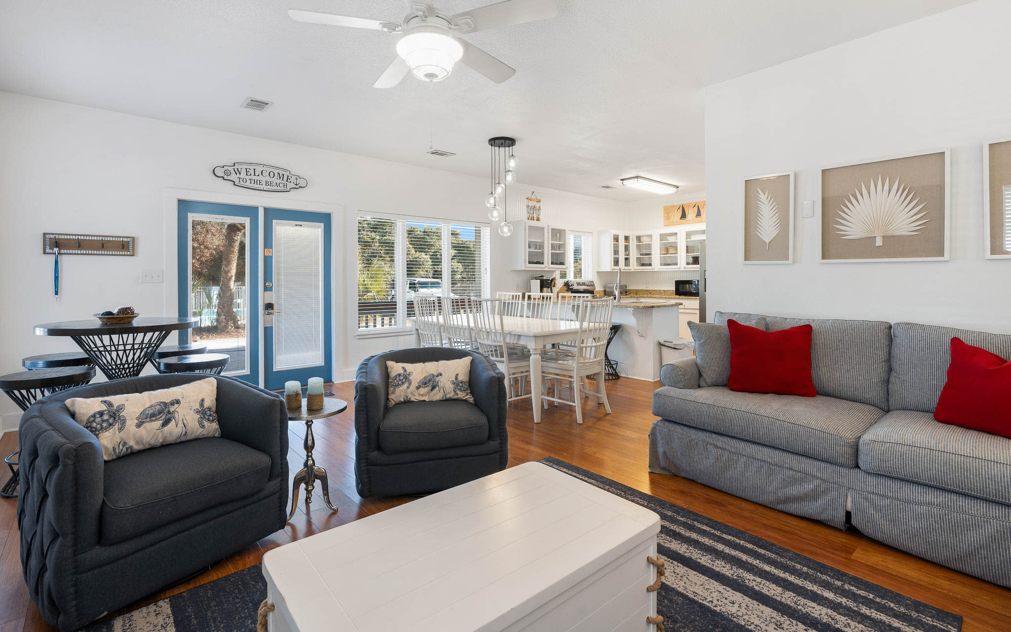 Relax in this bright, coastal-inspired living space where comfortable seating and an open layout create perfect gathering spots for your group.
