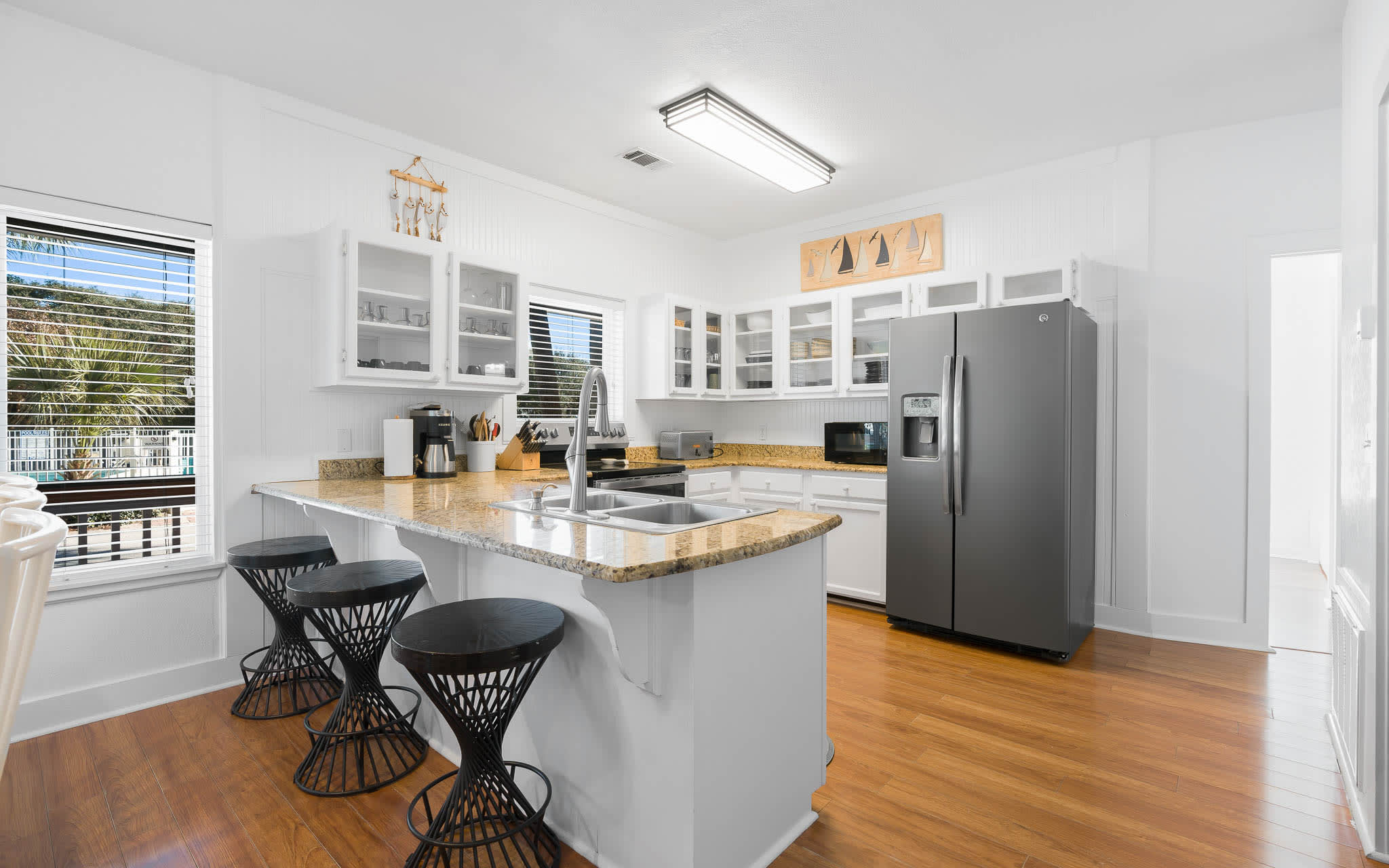 Your bright, fully-equipped kitchen features granite countertops, stainless steel appliances, and a breakfast bar perfect for morning coffee.