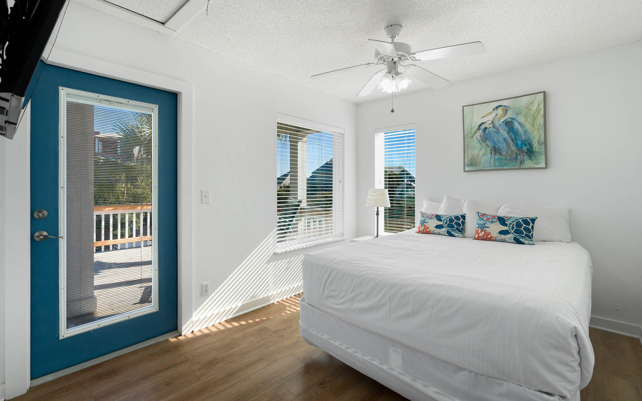 Drift off to sleep in your bright bedroom with coastal artwork and access to your private balcony.