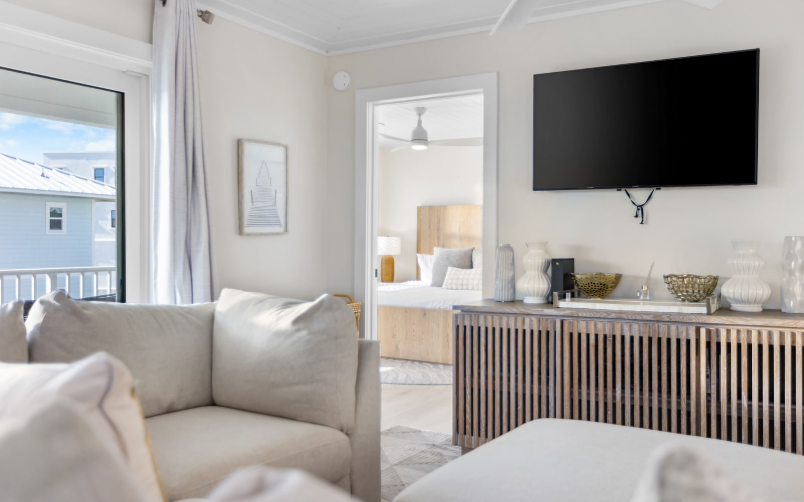 Sink into plush seating while enjoying your favorite shows on the wall-mounted TV, with stylish storage beneath and natural light streaming in.