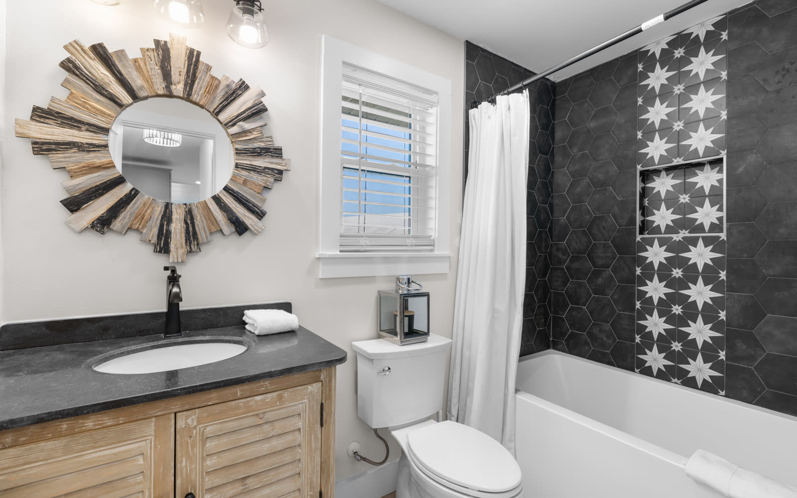 Soak in your stylish bathroom featuring a luxurious tub, elegant hexagonal tiles, and charming rustic vanity for the perfect relaxing retreat.