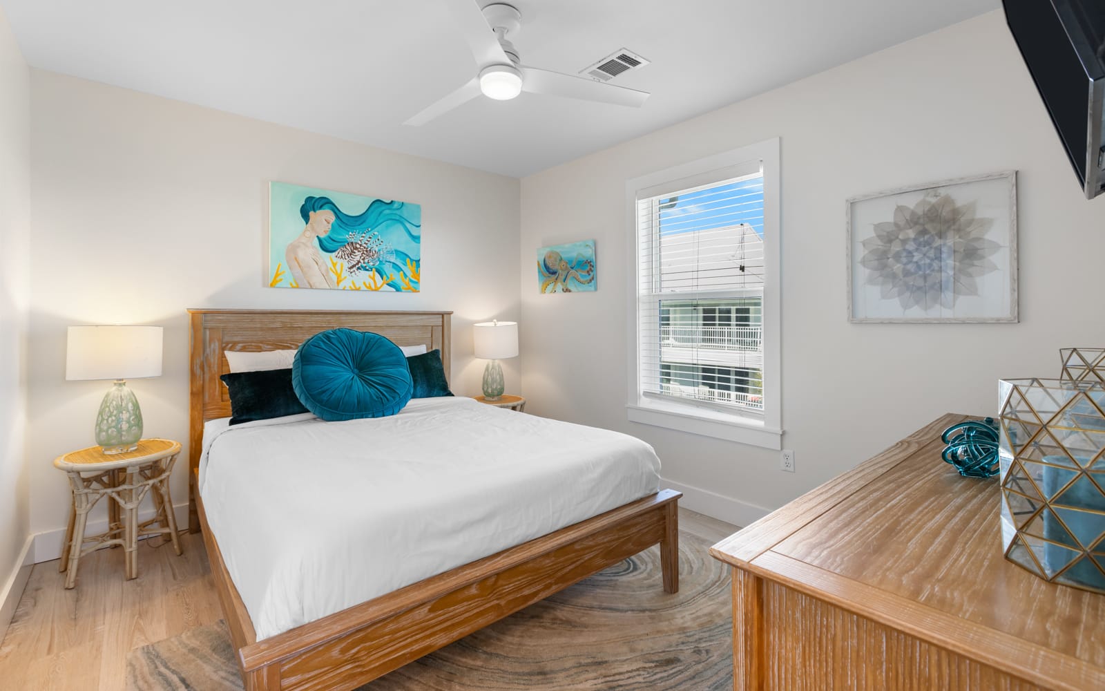 Drift into peaceful sleep in your serene bedroom, where coastal artwork and soft linens create the perfect retreat.